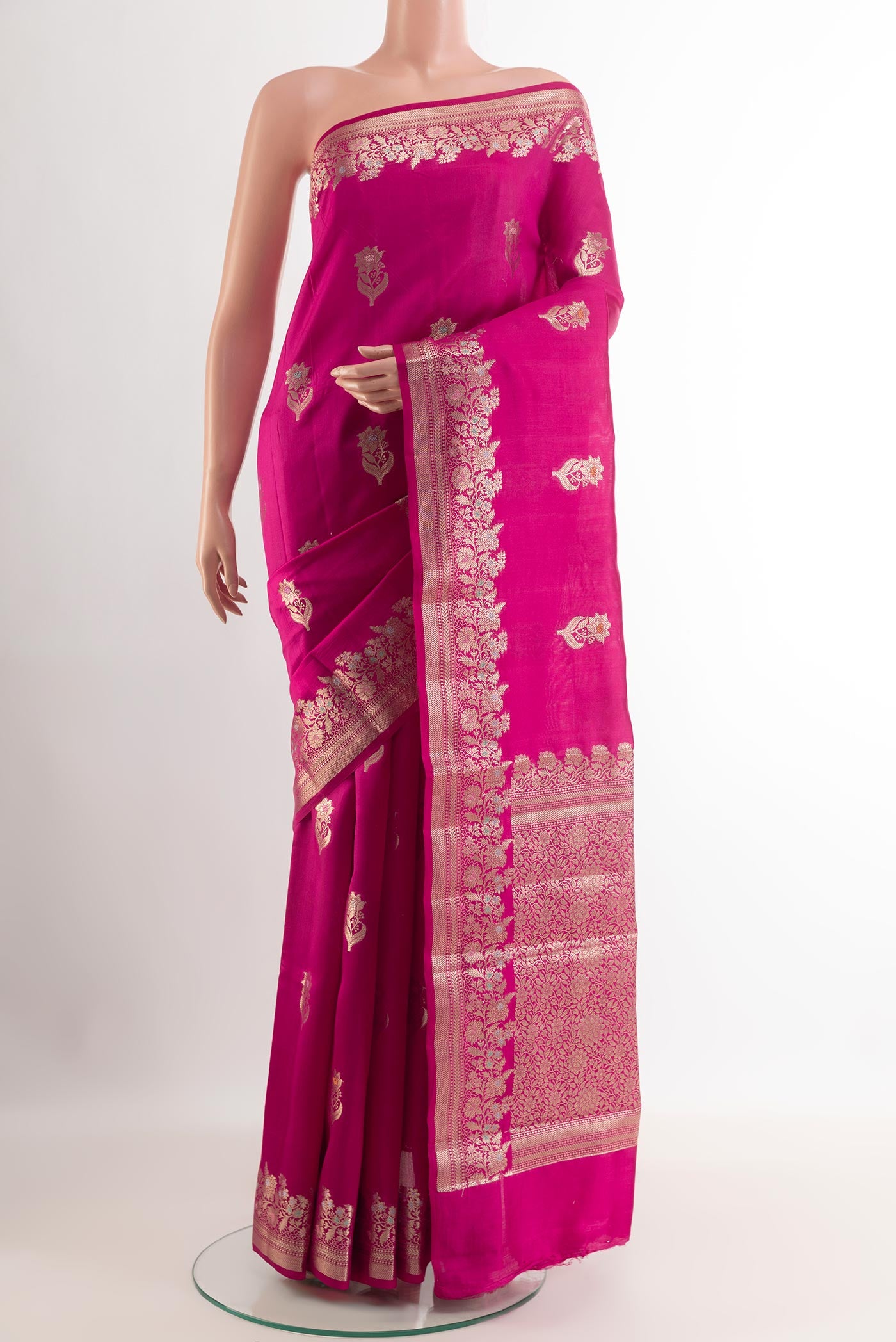 Pink Tussar Silk Saree with Zari Butta on the body and Zari Border.  displayed on a mannequin