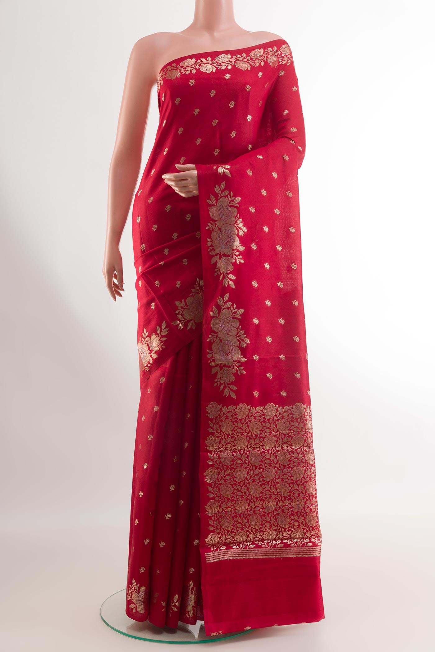 Red Tussar Silk Saree with Zari Butta on the body and Zari Border.  displayed on a mannequin