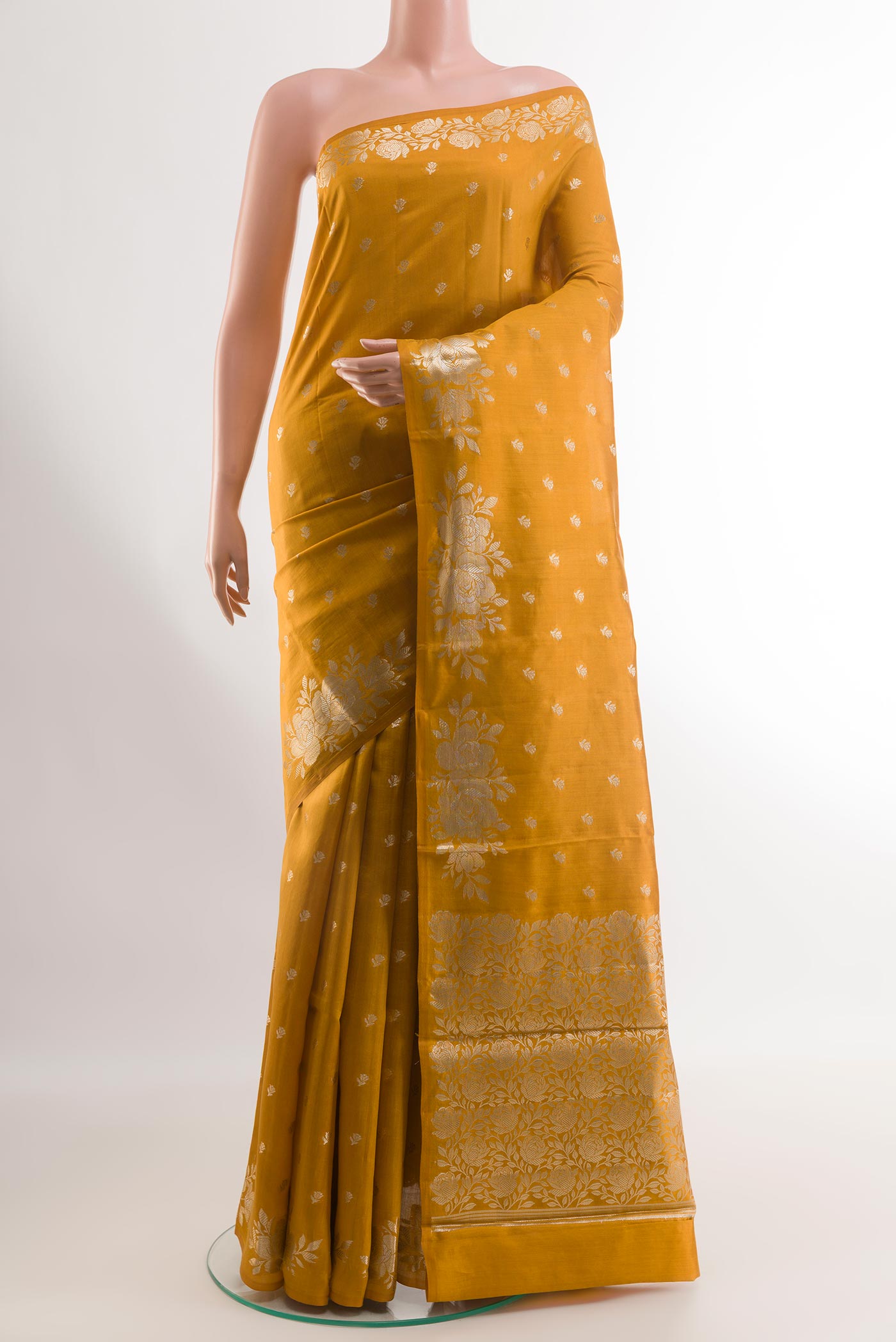 Yellow Tussar Silk Saree with Zari Butta on the body and Zari Border.  displayed on a mannequin