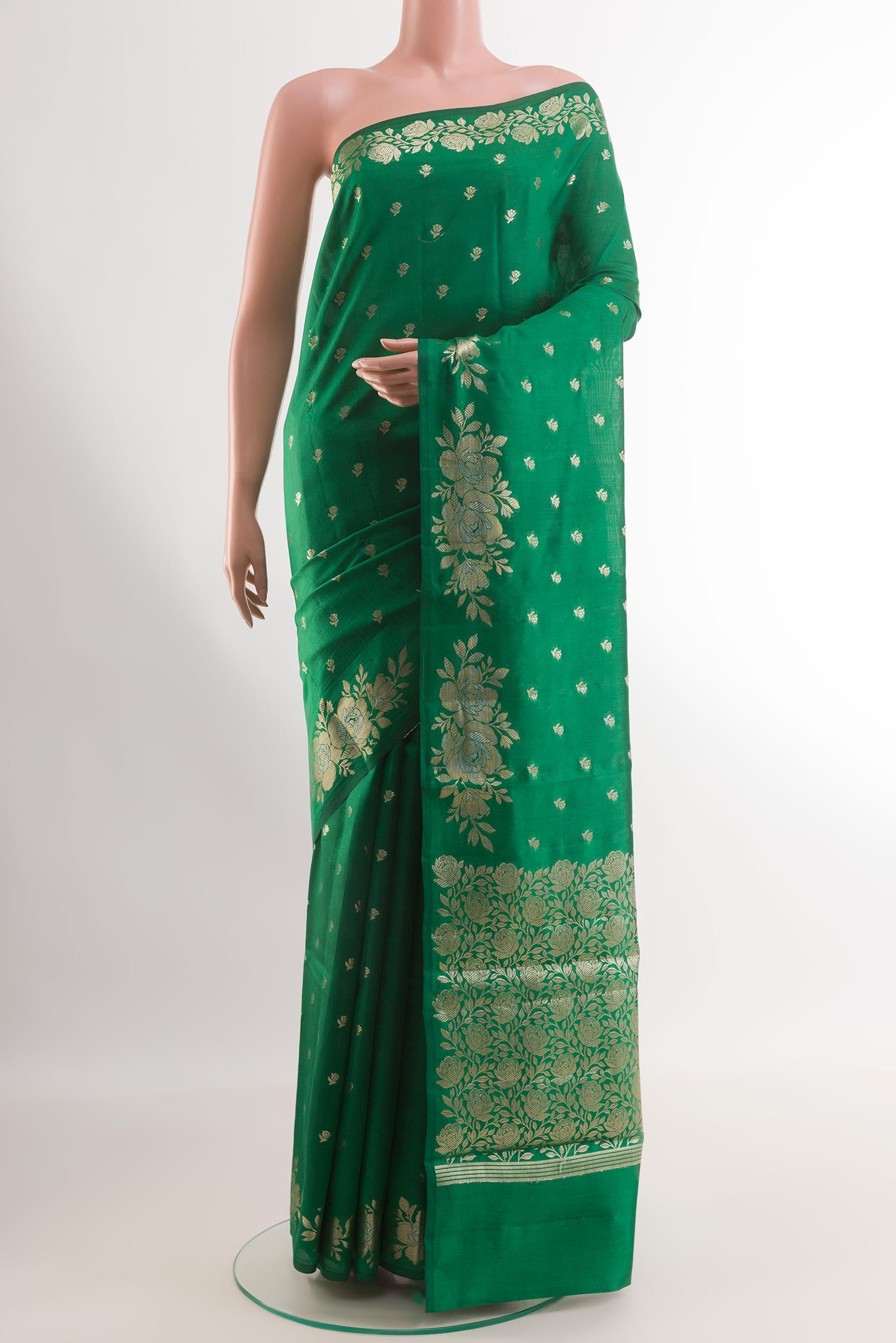 Green Tussar Silk Saree with Zari Butta on the body and Zari Border.  displayed on a mannequin