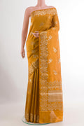 Yellow Tussar Silk Saree with Zari Butta on the body and Zari Border.  displayed on a mannequin