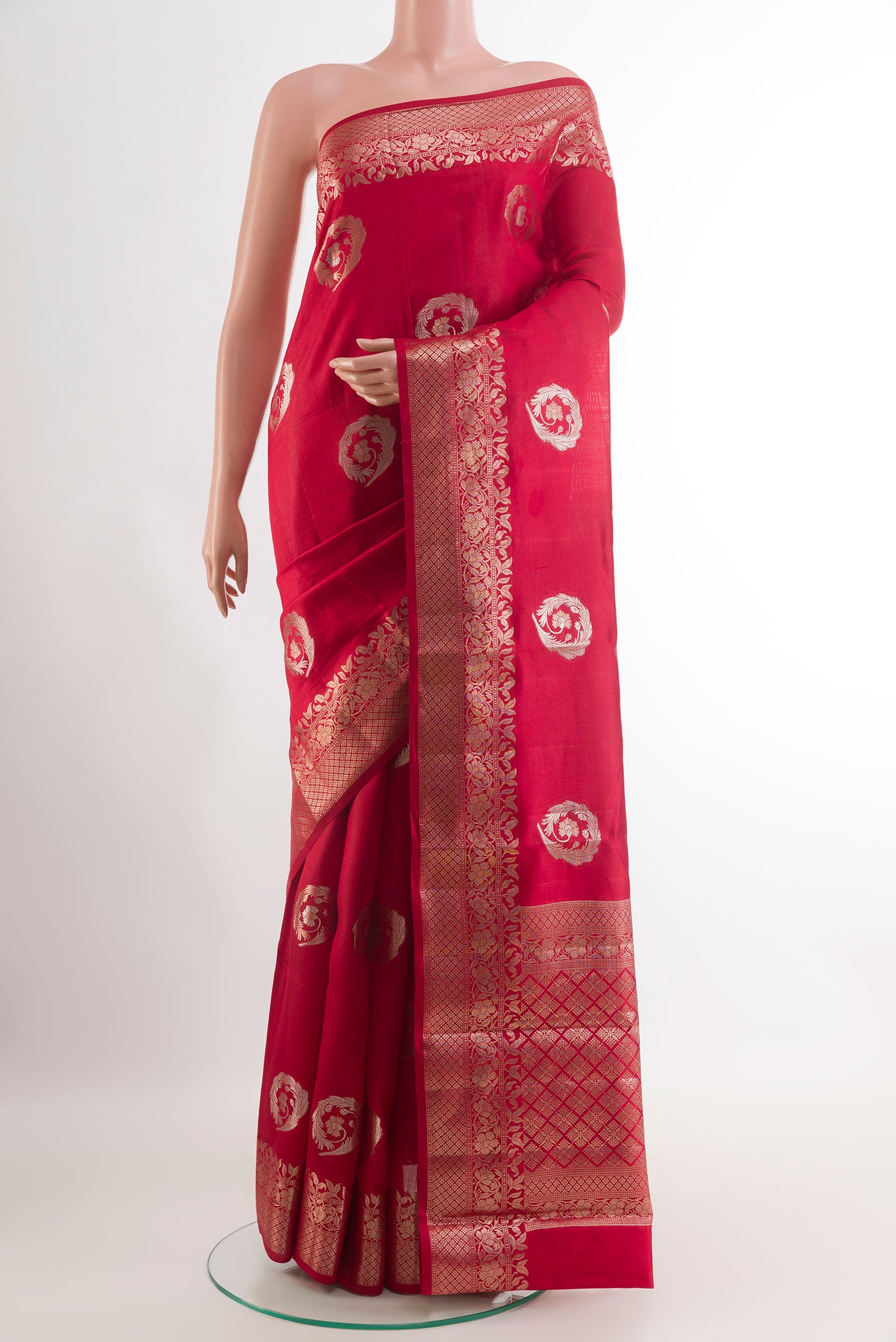 Red Tussar Silk Saree with Zari Butta on the body and Zari Border.  displayed on a mannequin