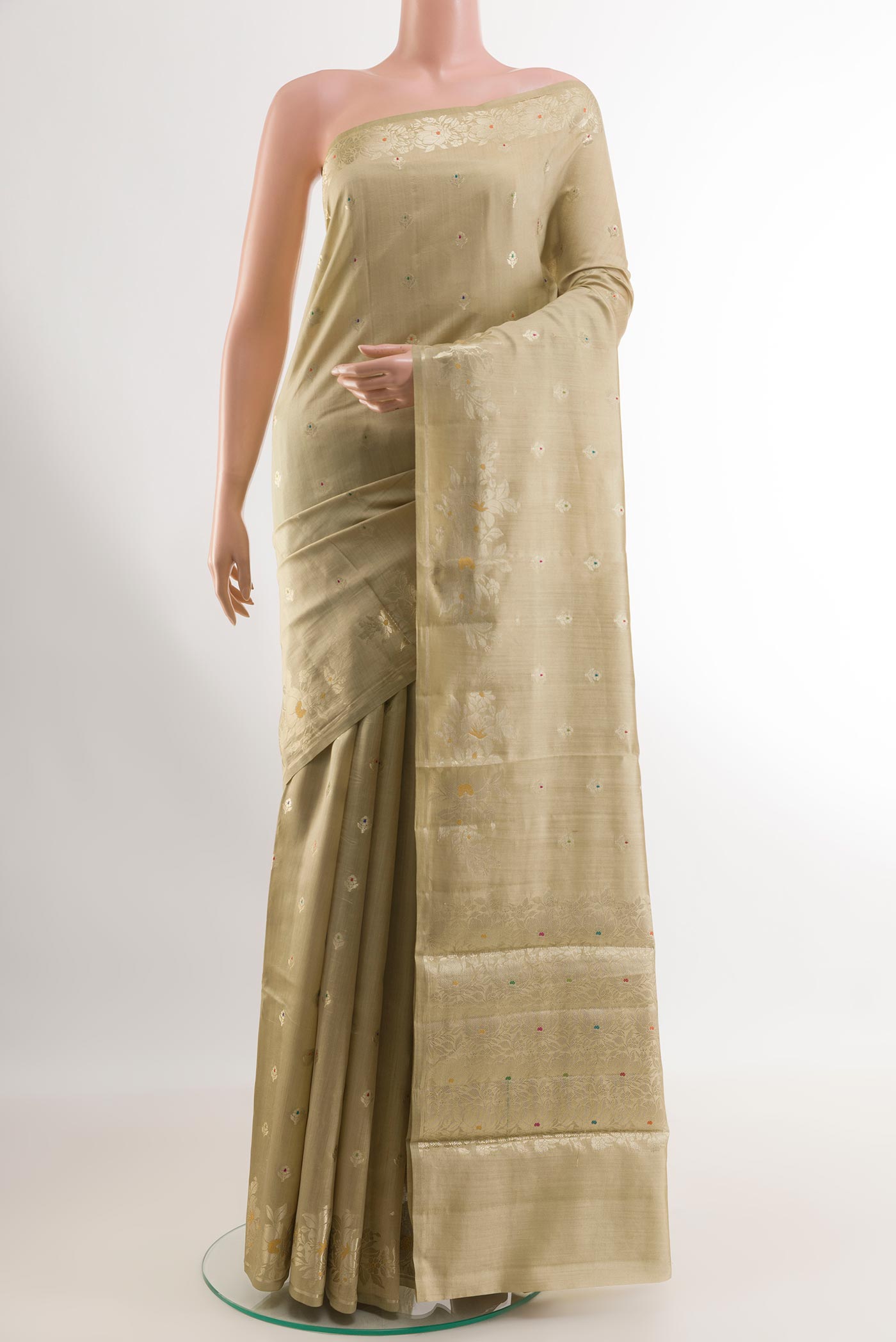 Beige Tussar Silk Saree with Zari Butta on the body and Zari Border.  displayed on a mannequin