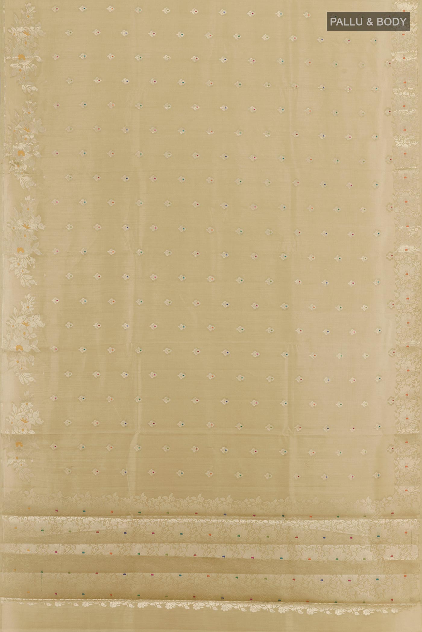 Flat view of Beige Tussar Silk Saree with Zari Butta on the body and Zari Border. 
