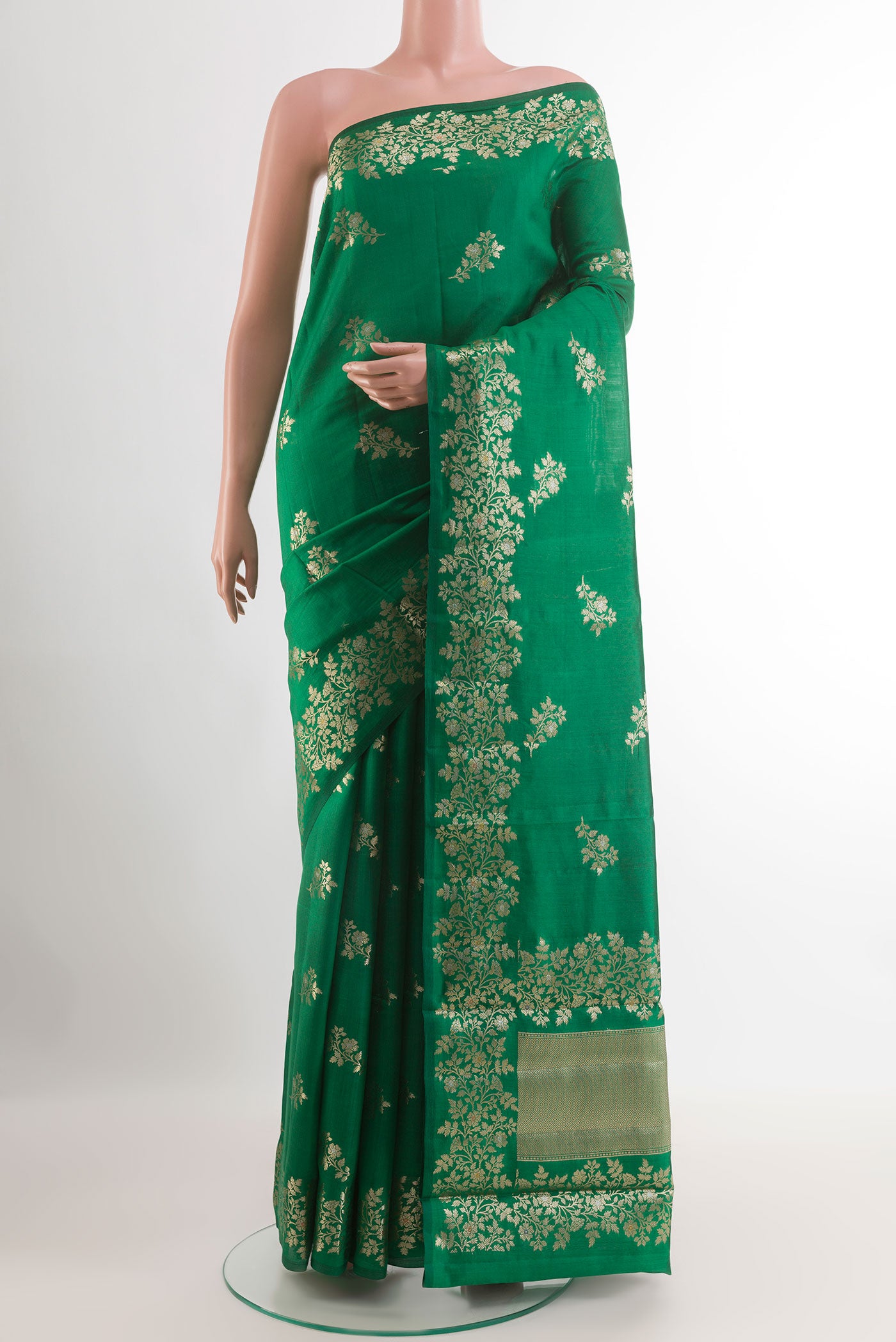 Green Tussar Silk Saree with Zari Butta on the body and Zari Border.  displayed on a mannequin