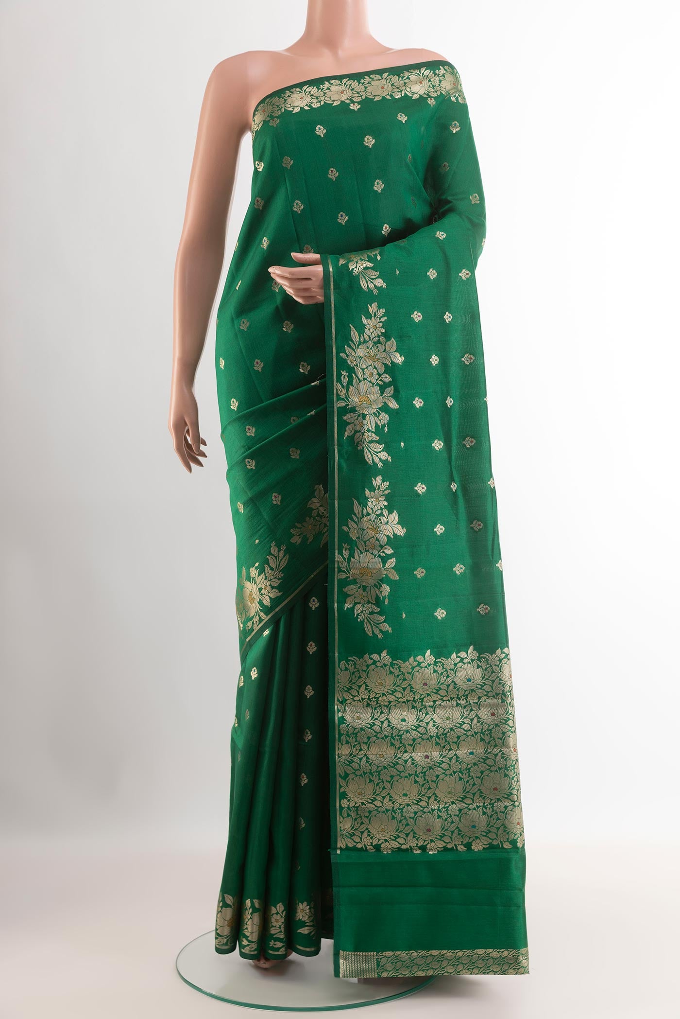 Green Tussar Silk Saree with Zari Butta on the body and Zari Border.  displayed on a mannequin