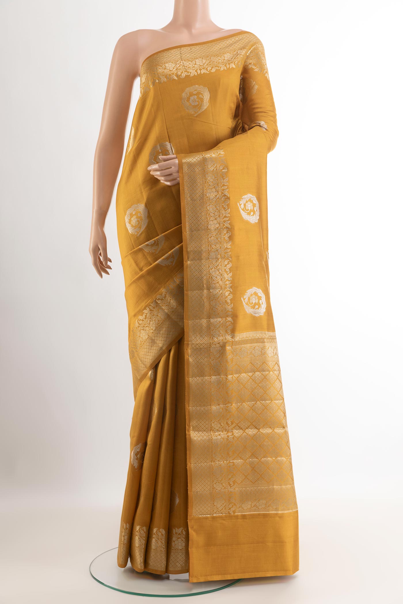 Yellow Tussar Silk Saree with Zari Butta on the body and Zari Border.  displayed on a mannequin