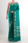 Sea Green Tussar Silk Saree with Zari Butta on the body and Zari Border.  displayed on a mannequin