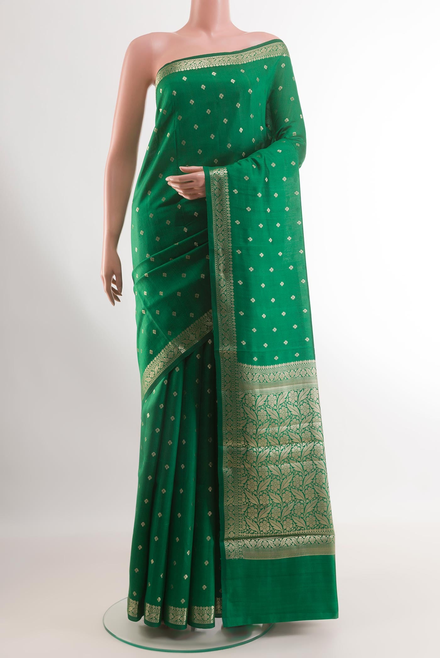 Green Tussar Silk Saree with Zari Butta on the body and Zari Border.  displayed on a mannequin