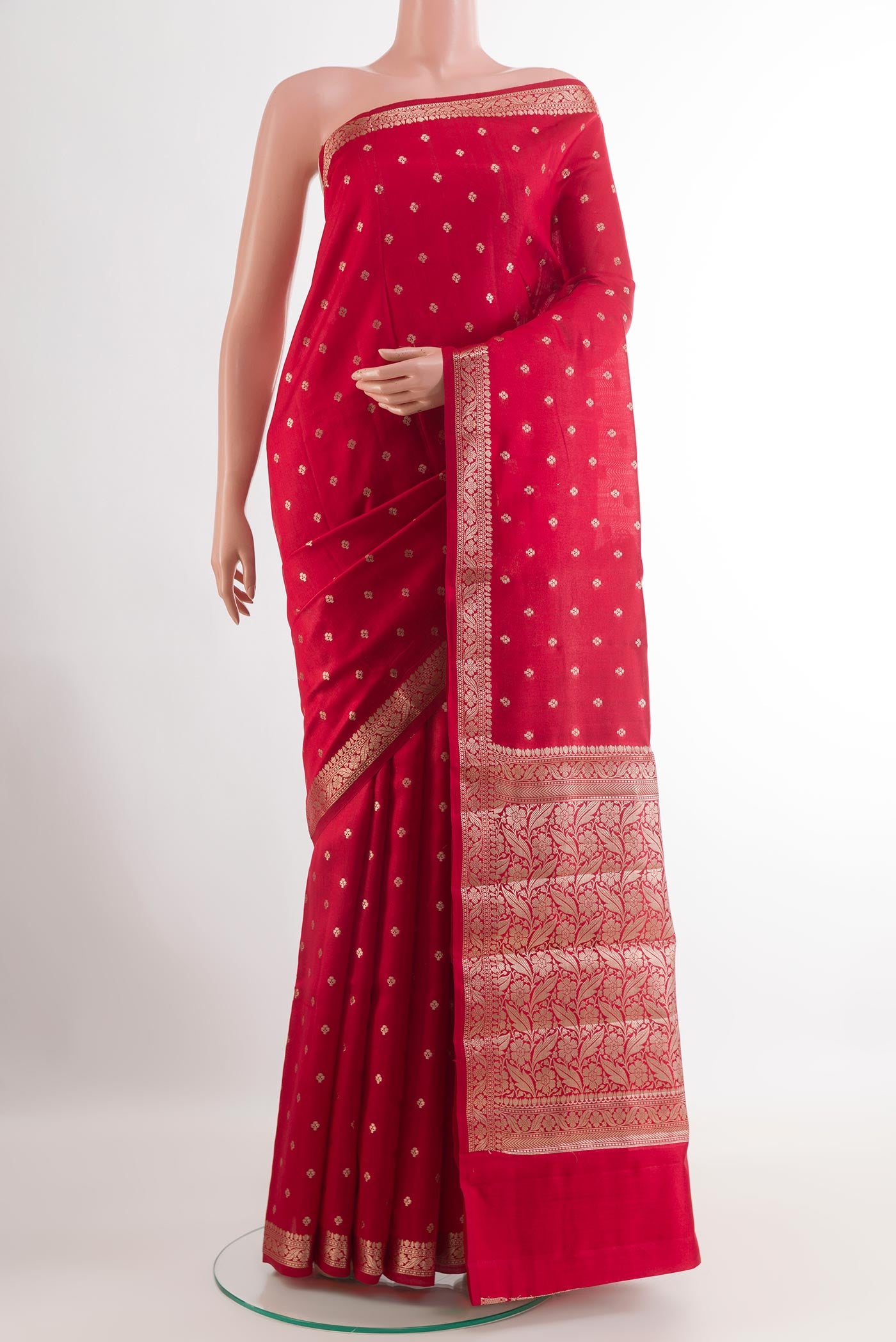 Red Tussar Silk Saree with Zari Butta on the body and Zari Border.  displayed on a mannequin