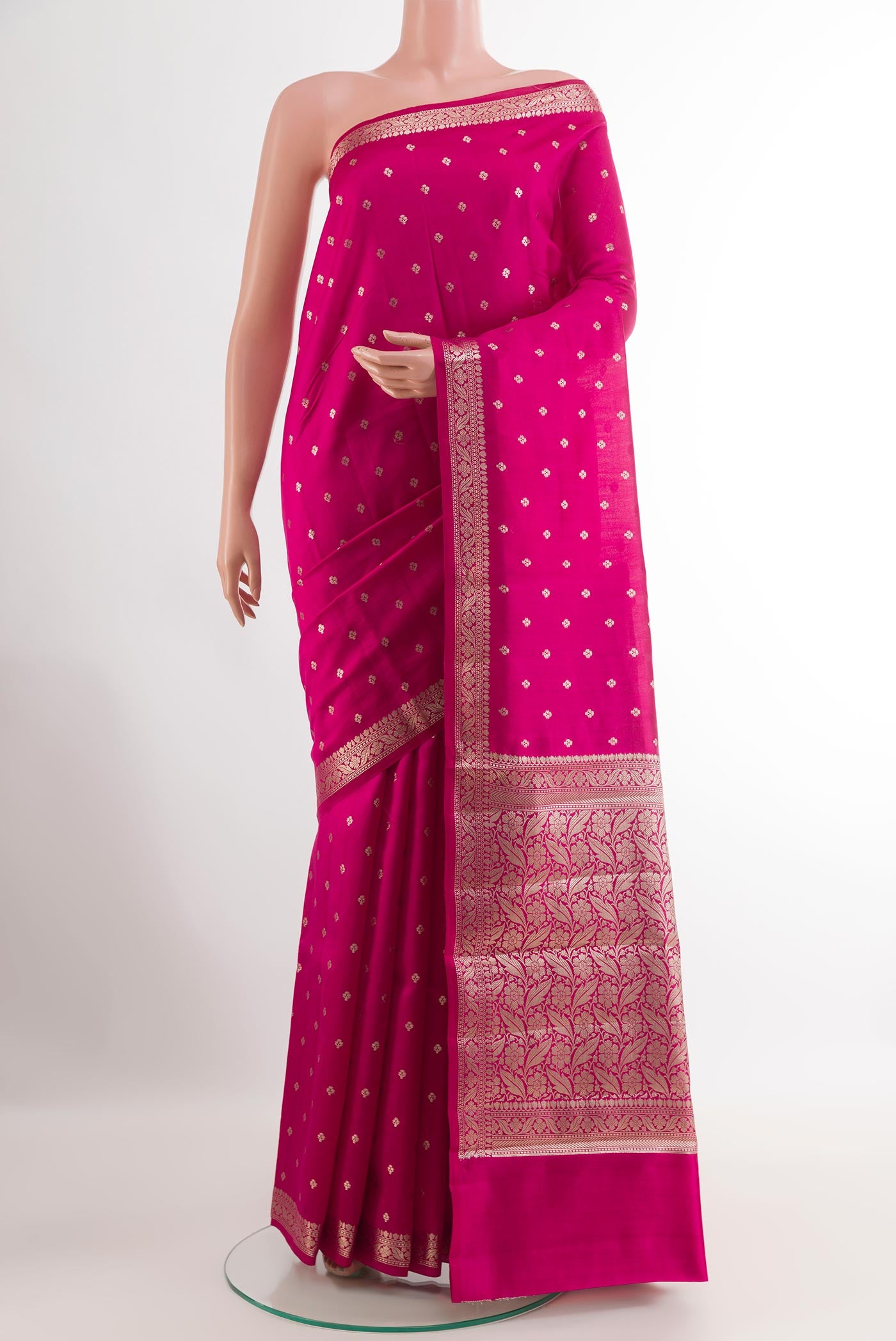 Pink Tussar Silk Saree with Zari Butta on the body and Zari Border.  displayed on a mannequin