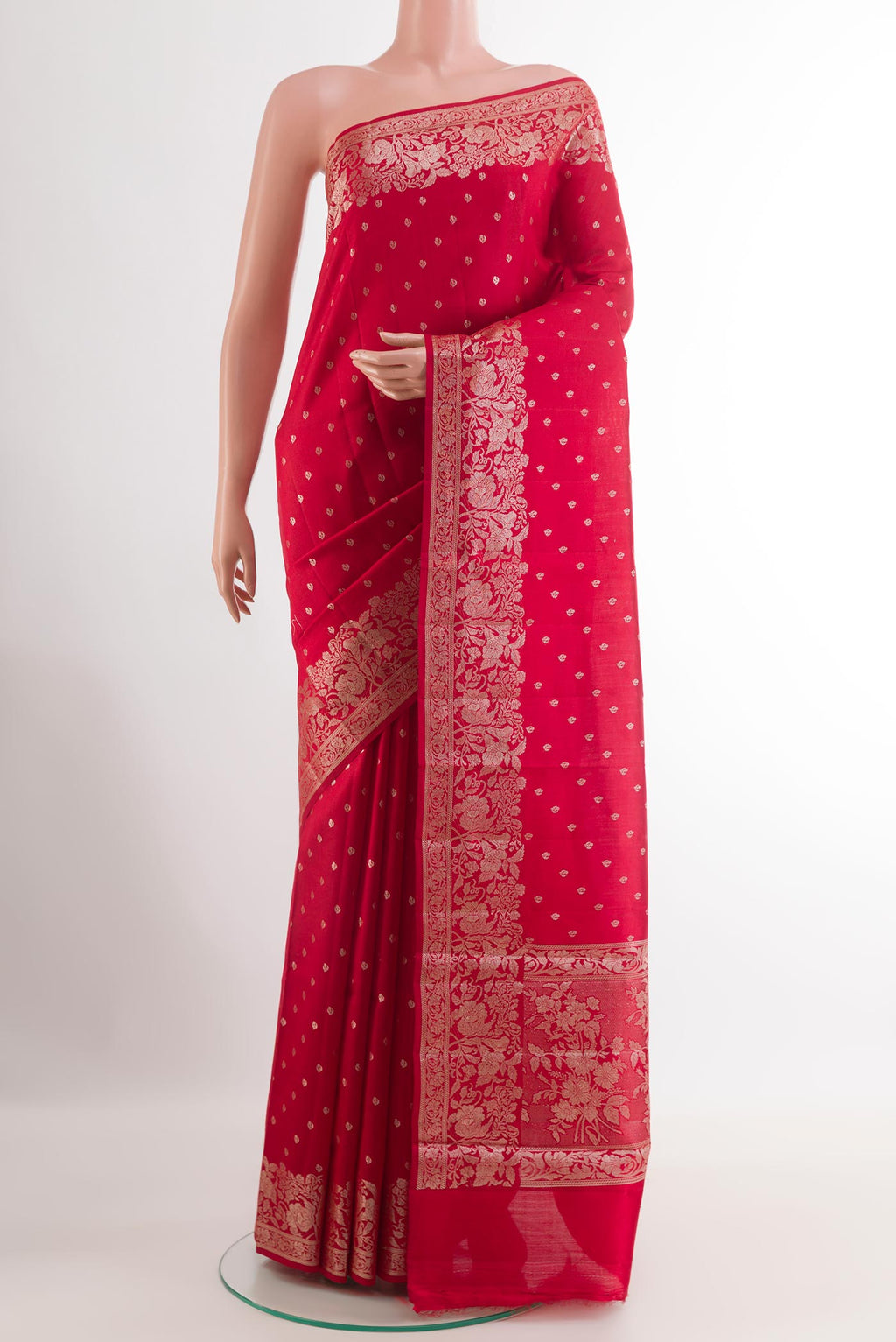Red Tussar Silk Saree with Zari Butta on the body and Zari Border.  displayed on a mannequin