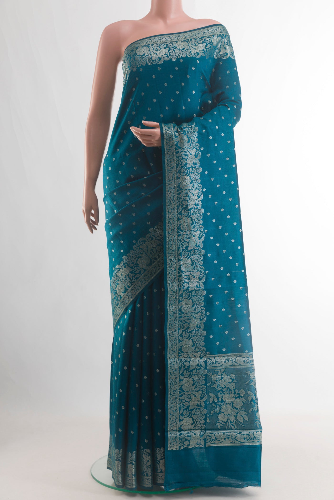 Blue Tussar Silk Saree with Zari Butta on the body and Zari Border.  displayed on a mannequin