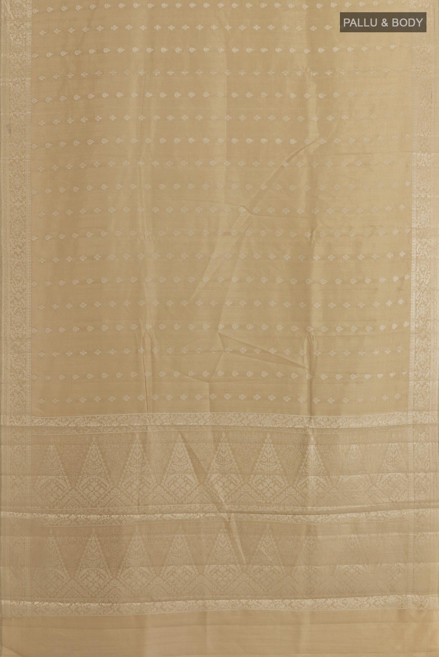 Flat view of Beige Tussar Silk Saree with Zari Butta on the body and Zari Border. 