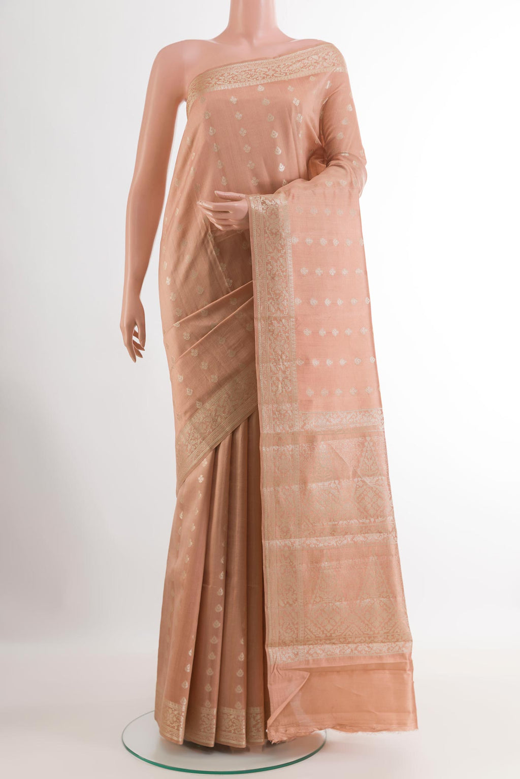 Beige Tussar Silk Saree with Zari Butta on the body and Zari Border.  displayed on a mannequin