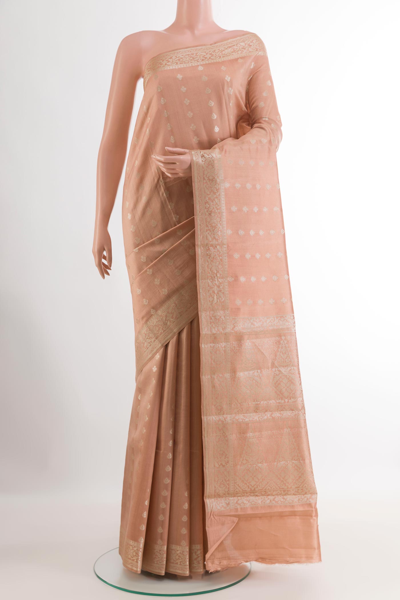 Beige Tussar Silk Saree with Zari Butta on the body and Zari Border.  displayed on a mannequin