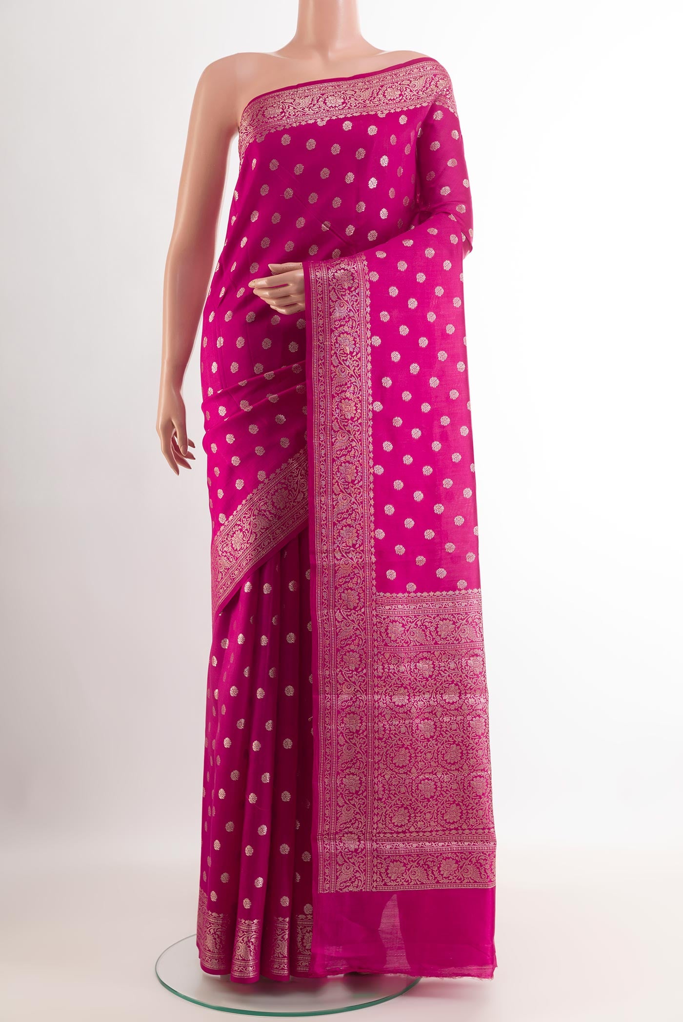 Pink Tussar Silk Saree with Zari Butta on the body and Zari Border.  displayed on a mannequin