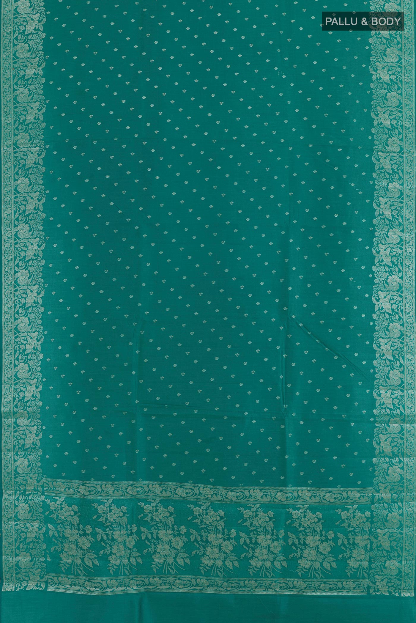 Flat view of Sea Green Tussar Silk Saree with Zari Butta on the body and Zari Border. 
