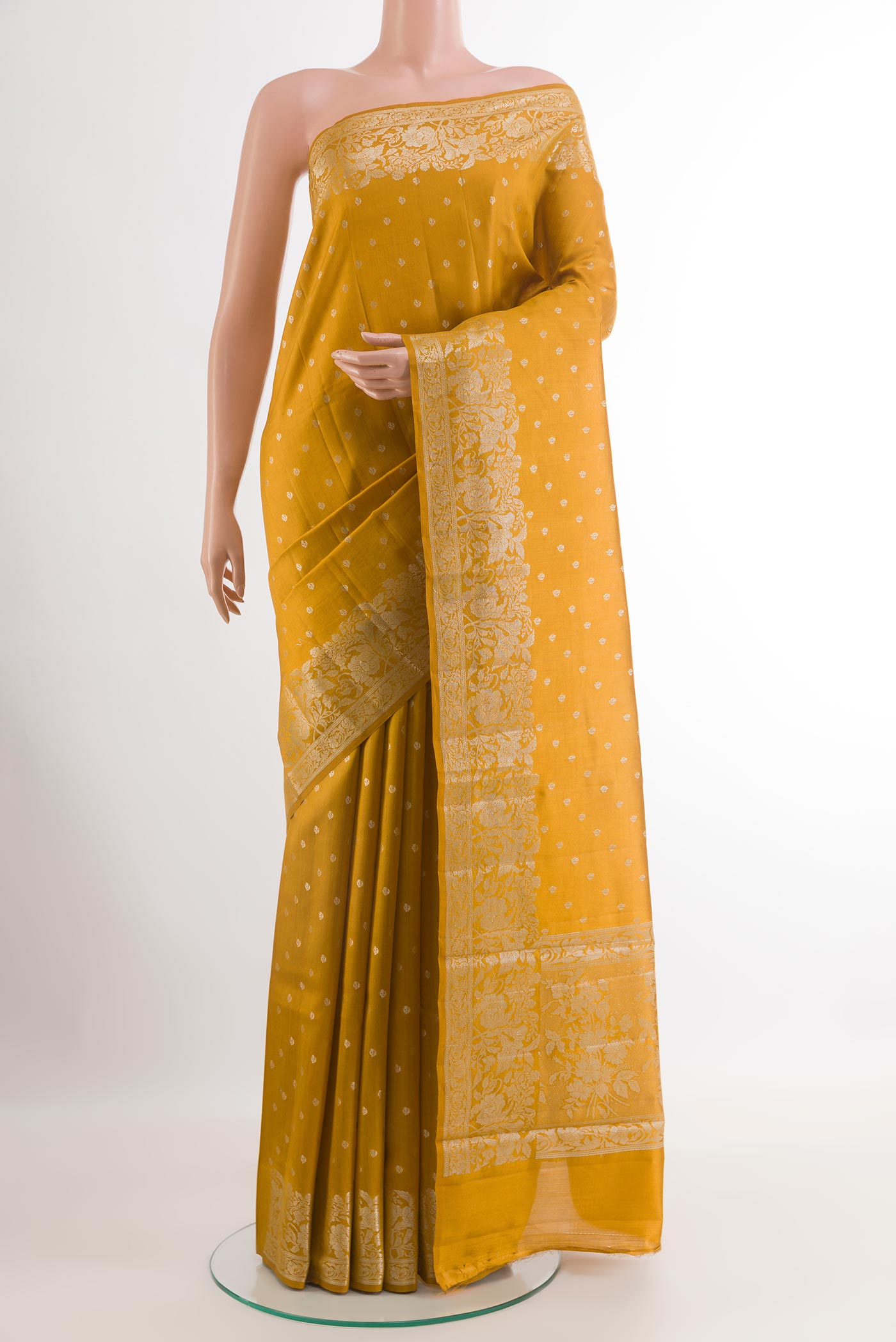 Yellow Tussar Silk Saree with Zari Butta on the body and Zari Border.  displayed on a mannequin