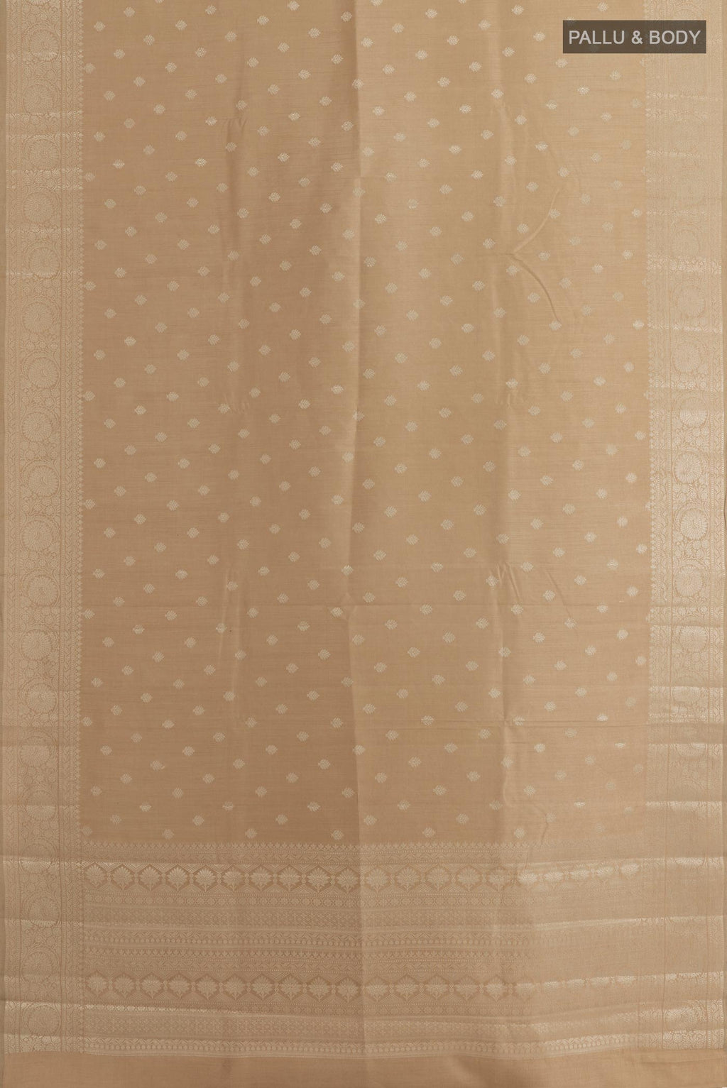 Flat view of Beige Tussar Silk Saree with Zari Butta on the body and Zari Border. 