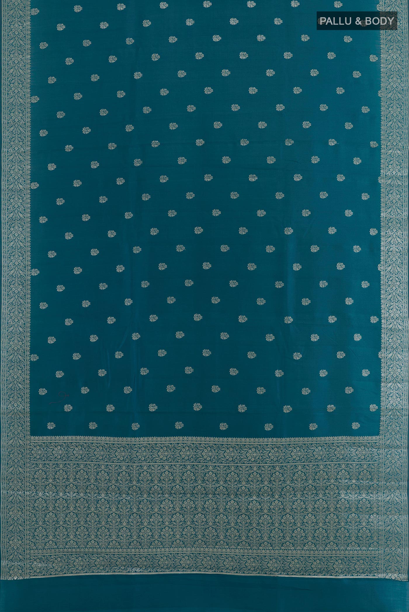 Flat view of Blue Tussar Silk Saree with Zari Butta on the body and Zari Border. 