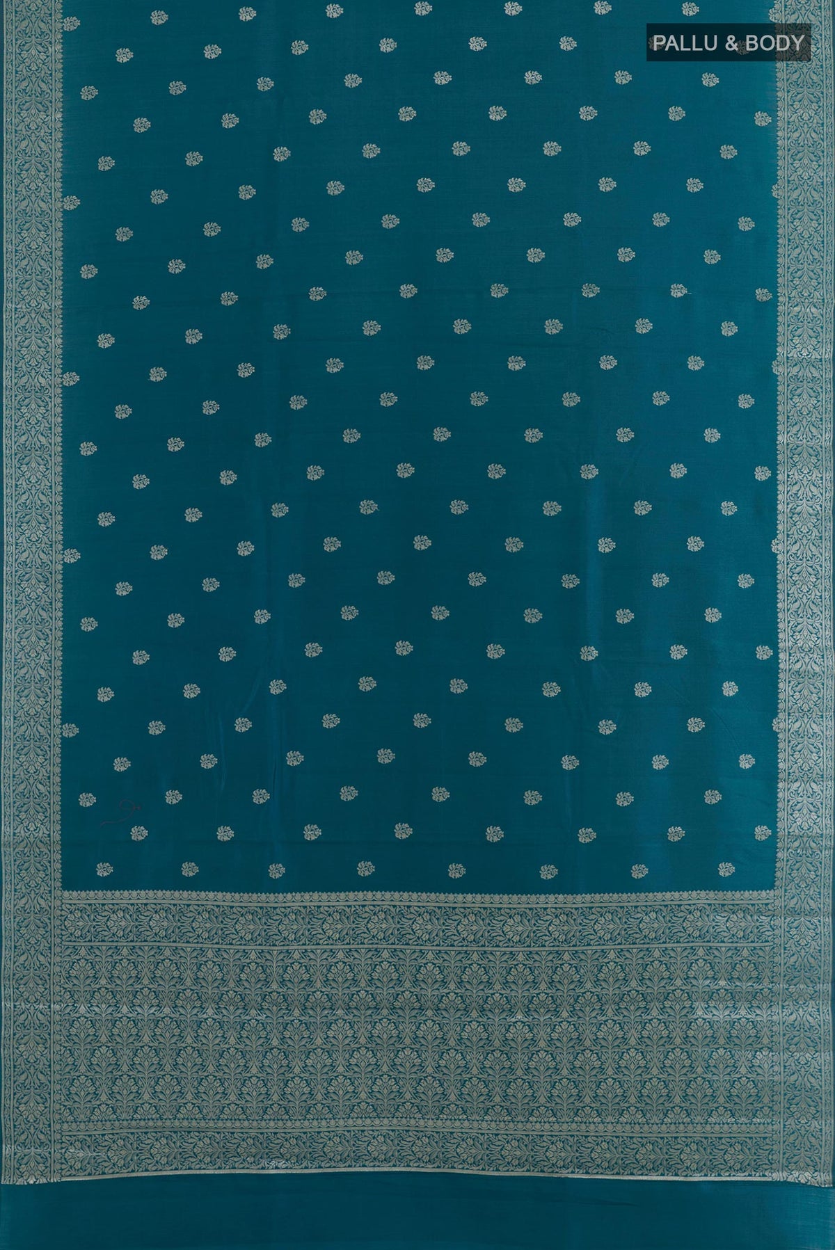 Flat view of Blue Tussar Silk Saree with Zari Butta on the body and Zari Border. 