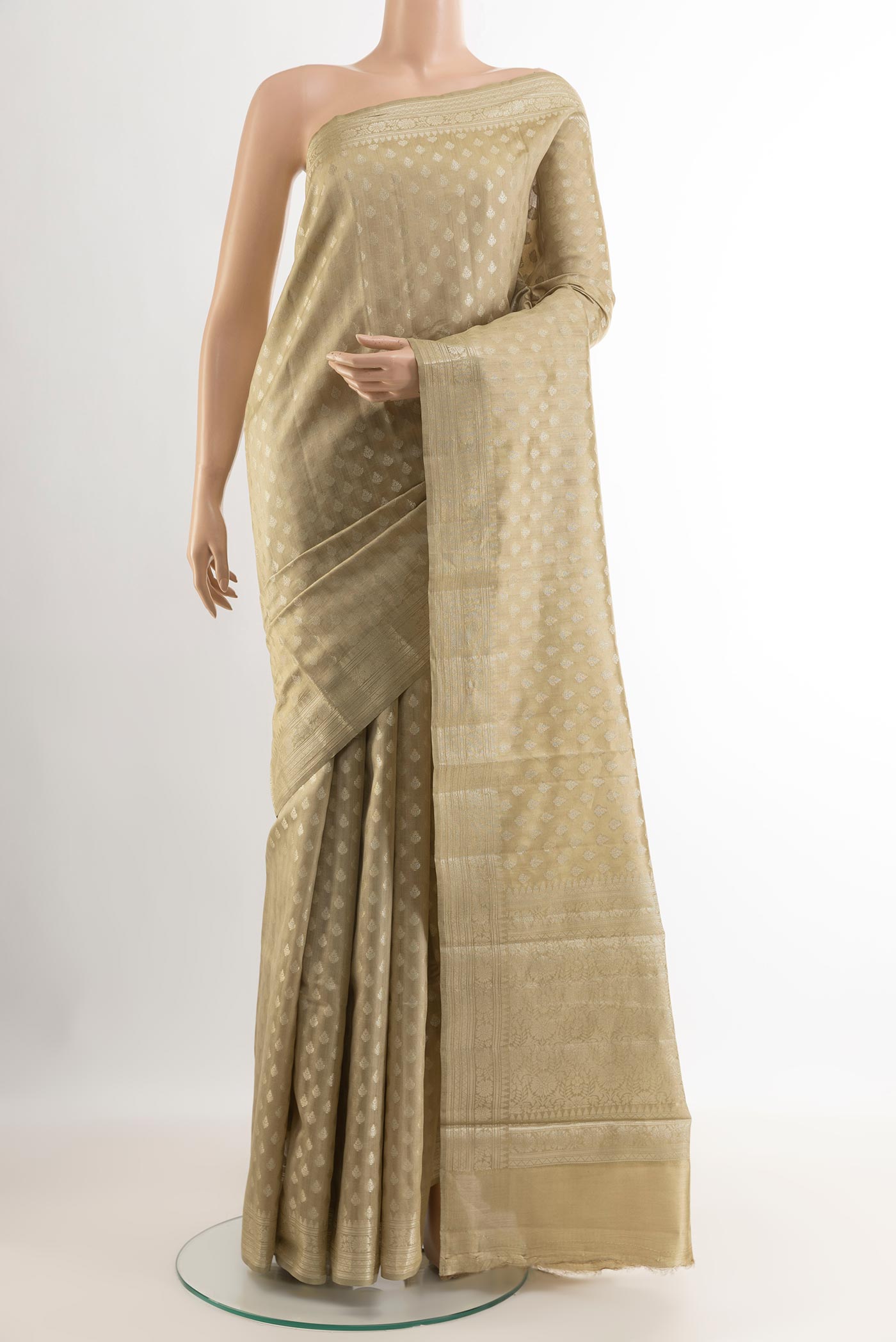 Beige Tussar Silk Saree with Zari Butta on the body and Zari Border.  displayed on a mannequin