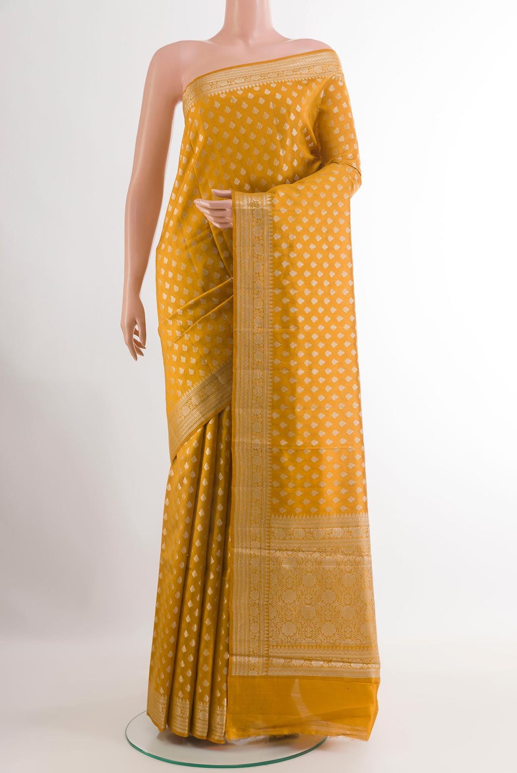 Yellow Tussar Silk Saree with Zari Butta on the body and Zari Border.  displayed on a mannequin