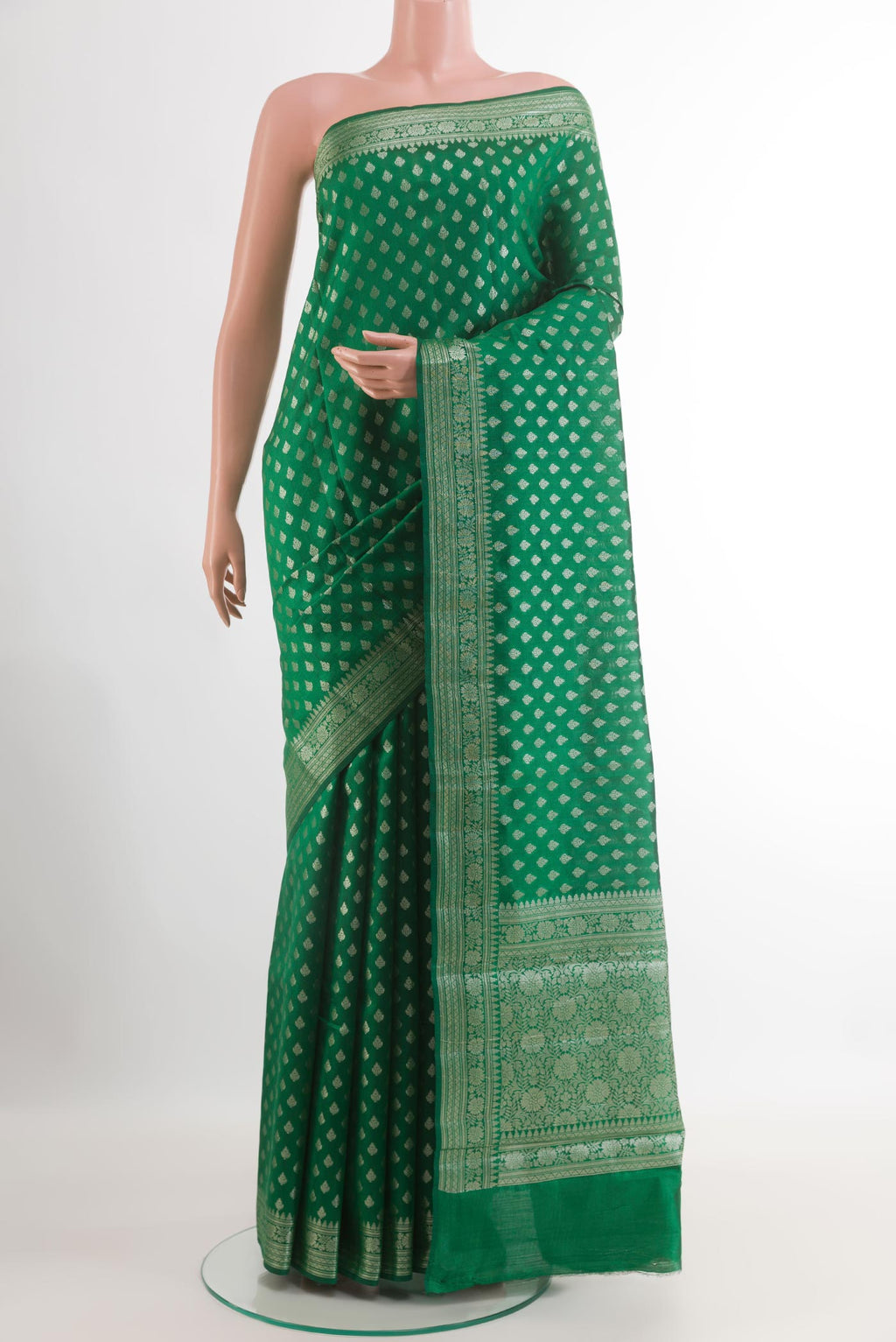 Green Tussar Silk Saree with Zari Butta on the body and Zari Border.  displayed on a mannequin