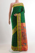 Green Gadwal Silk Saree with Zari Butta on the body and Zari Border.  displayed on a mannequin