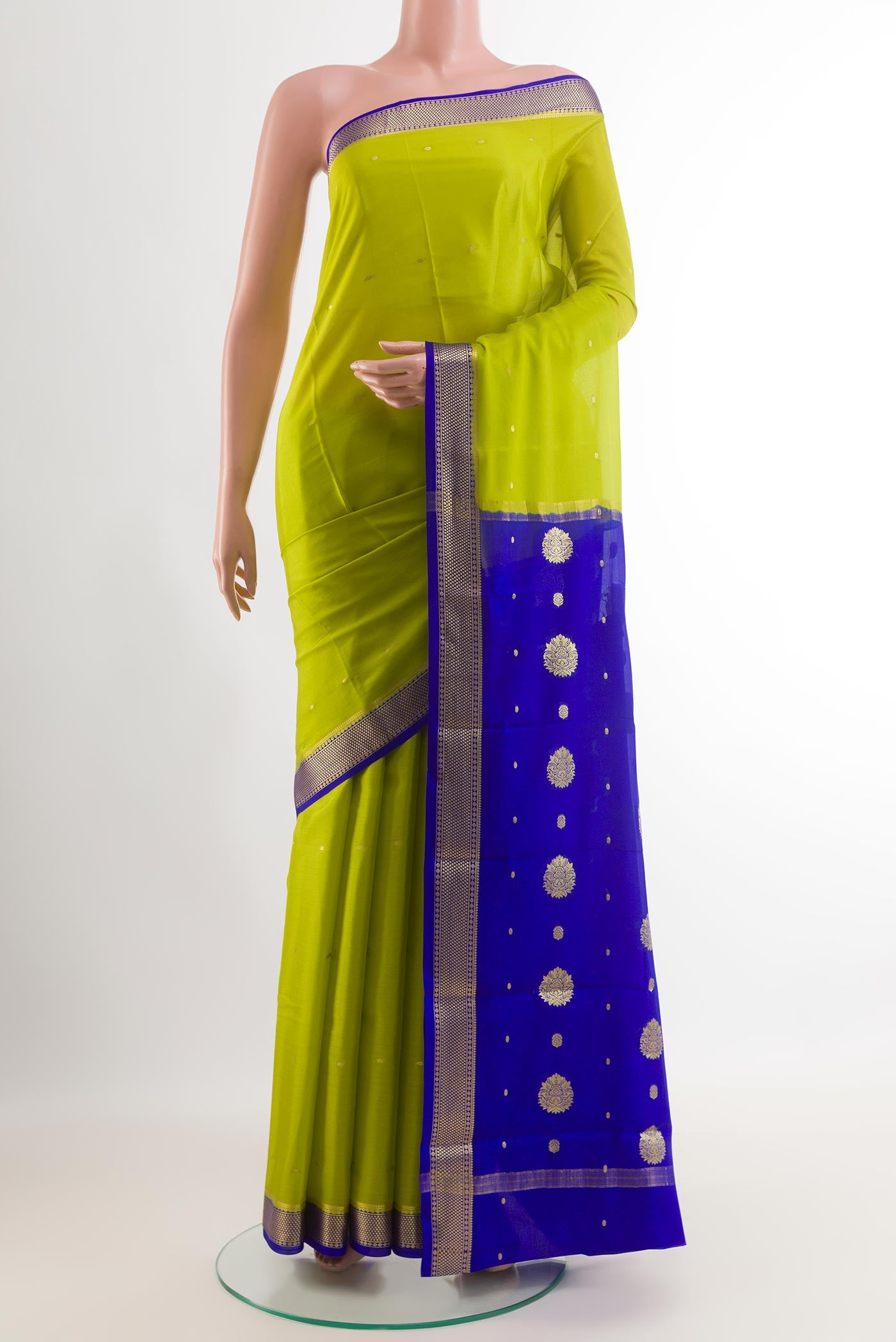 Green Mysore Silk Saree with Zari Butta on the body and Zari Border.  displayed on a mannequin