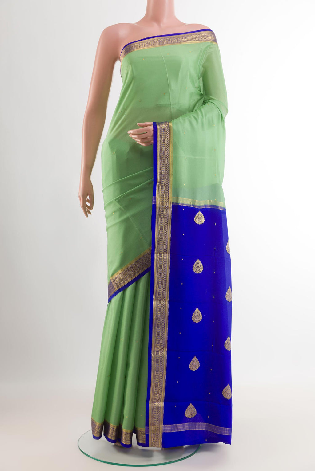 Green Mysore Silk Saree with Zari Butta on the body and Zari Border.  displayed on a mannequin