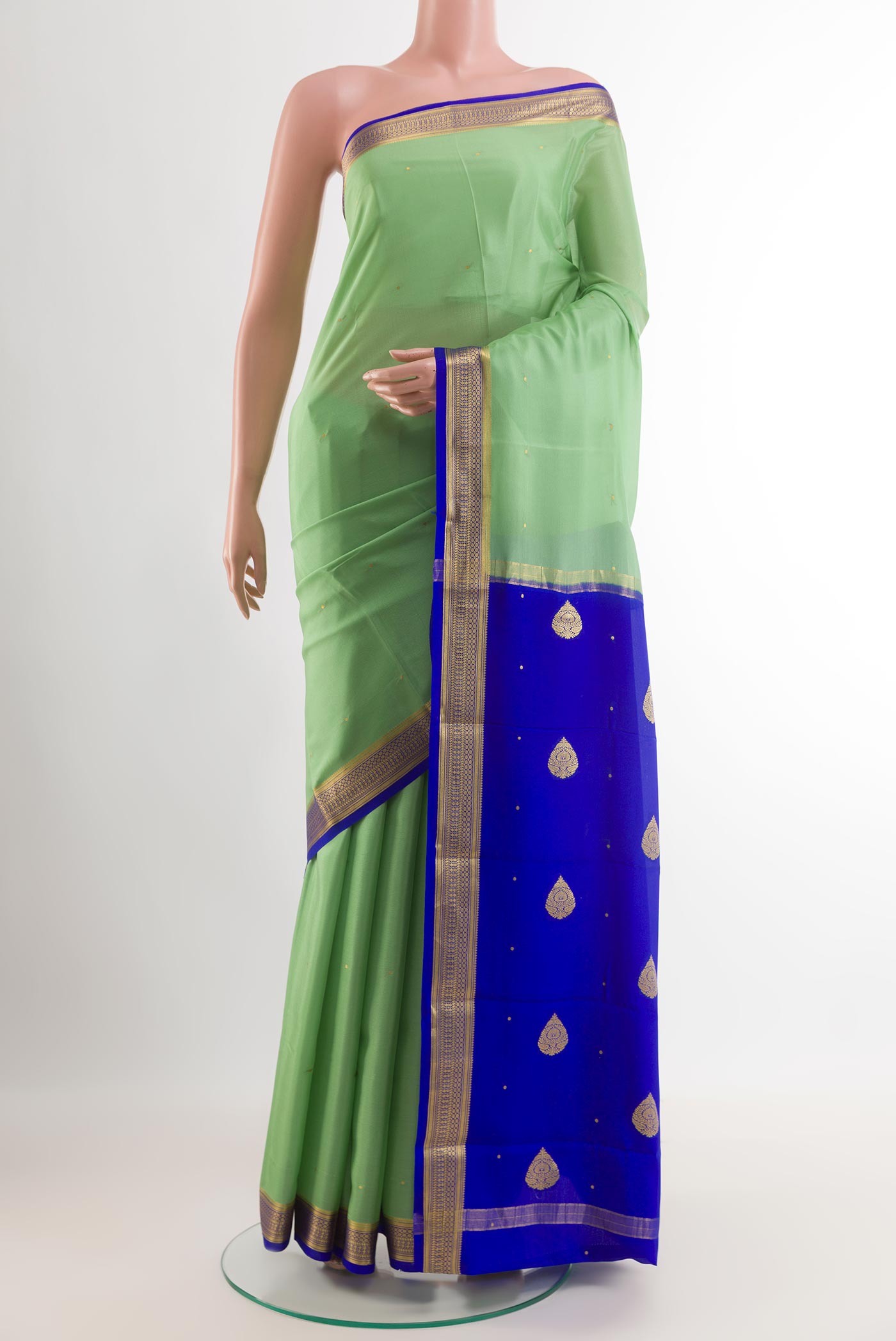 Green Mysore Silk Saree with Zari Butta on the body and Zari Border.  displayed on a mannequin