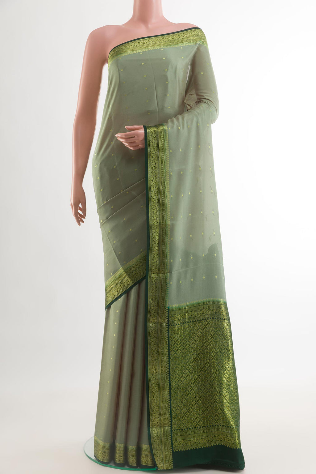Sage Green Mysore Crepe Saree with Zari Butta on the body and Zari Border.  displayed on a mannequin