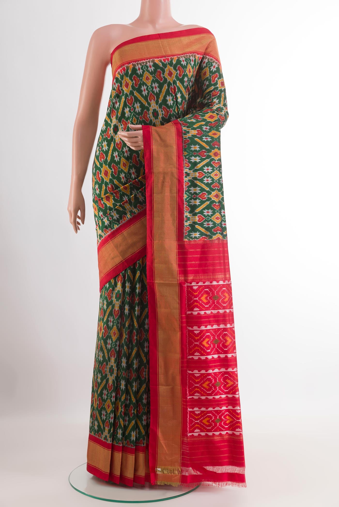 Green Pochampally Silk Saree with Pure Ikat on the body and Zari Border.  displayed on a mannequin