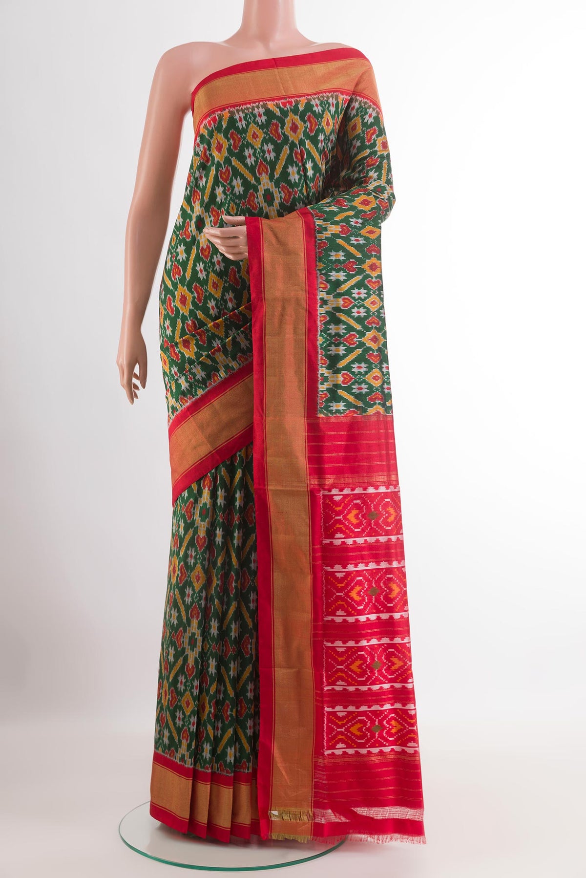 Green Pochampally Silk Saree with Pure Ikat on the body and Zari Border.  displayed on a mannequin