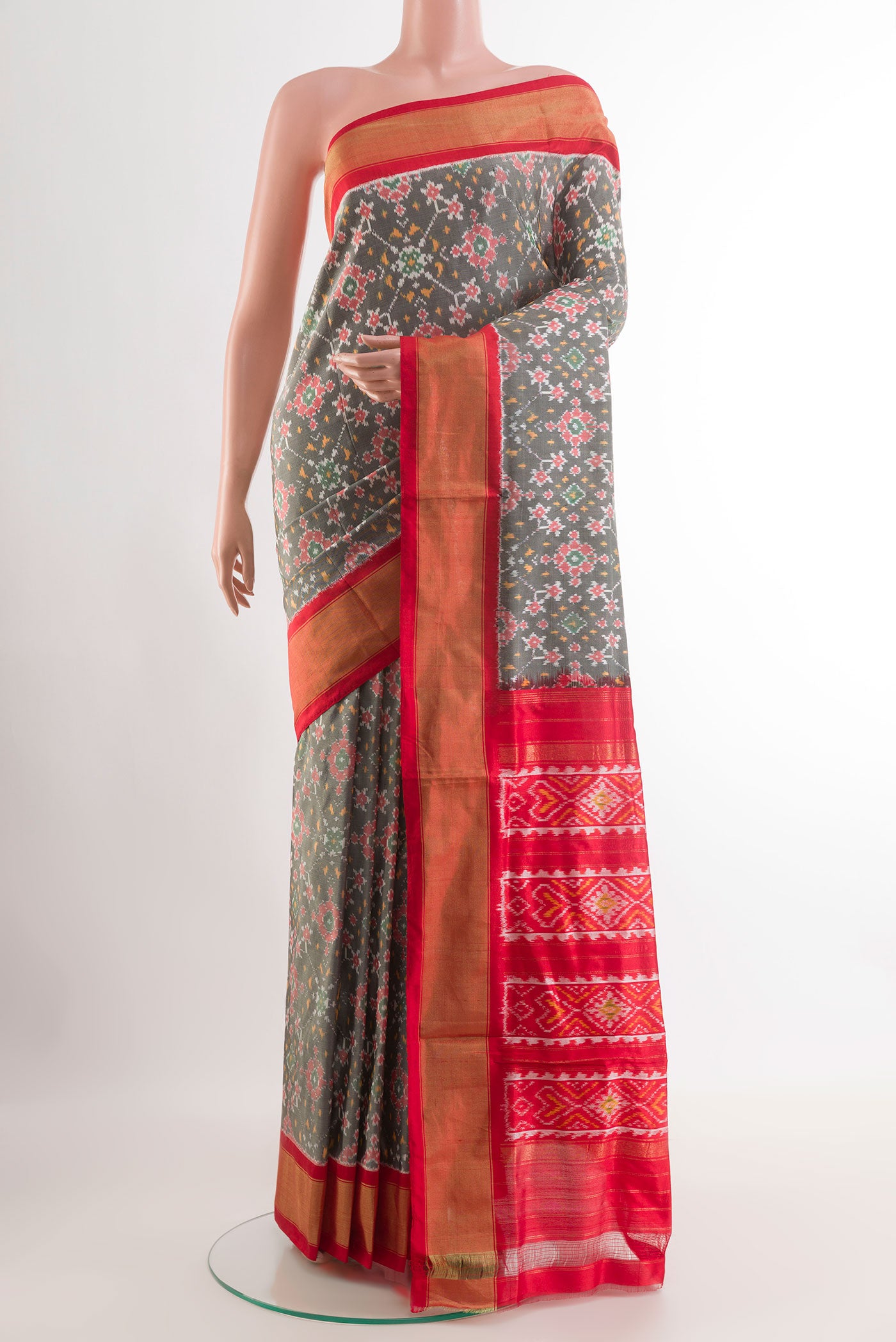Black Rajkot Patola Silk Saree with Pure Ikat on the body and Zari Border.  displayed on a mannequin