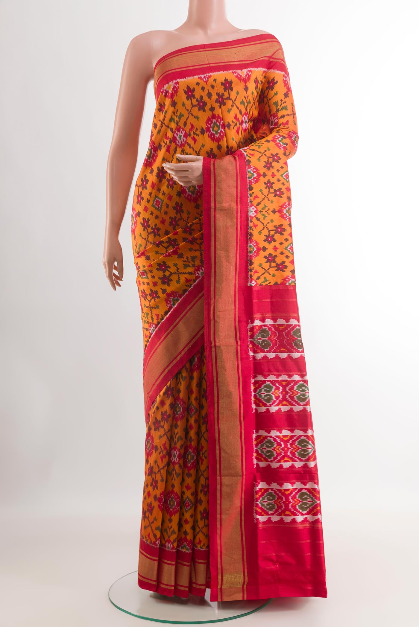 Mustard Pochampally Silk Saree with Ikat design on the body and Zari Border.  displayed on a mannequin