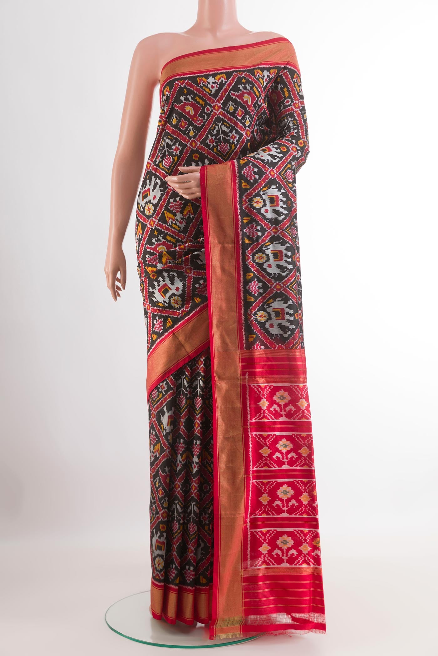 Black Pochampally Silk Saree with Pure Ikat on the body and Zari Border.  displayed on a mannequin