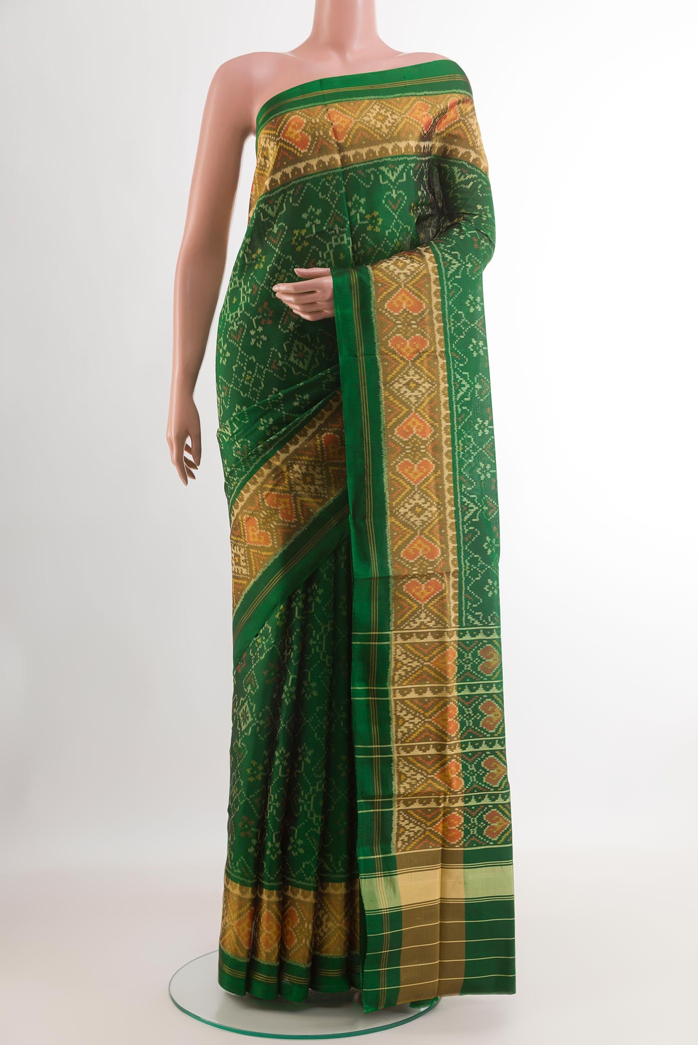 Green Rajkot Patola Silk Saree with Ikat design on the body and Zari Border.  displayed on a mannequin