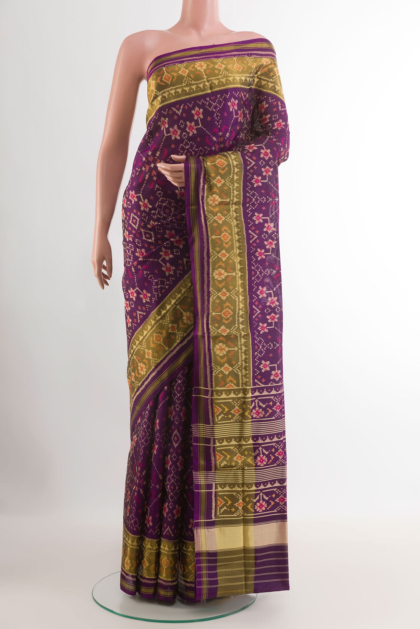 Purple Rajkot Patola Silk Saree with Pure Ikat on the body and Zari Border.  displayed on a mannequin