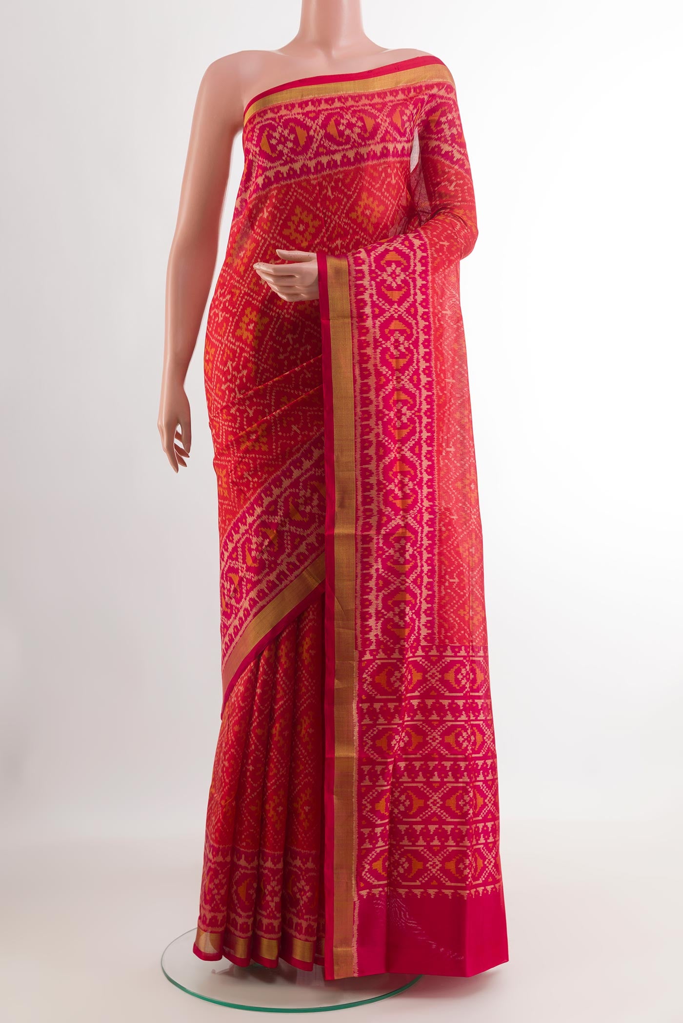 Red Rajkot Patola Silk Saree with Ikat design on the body and Zari Border.  displayed on a mannequin