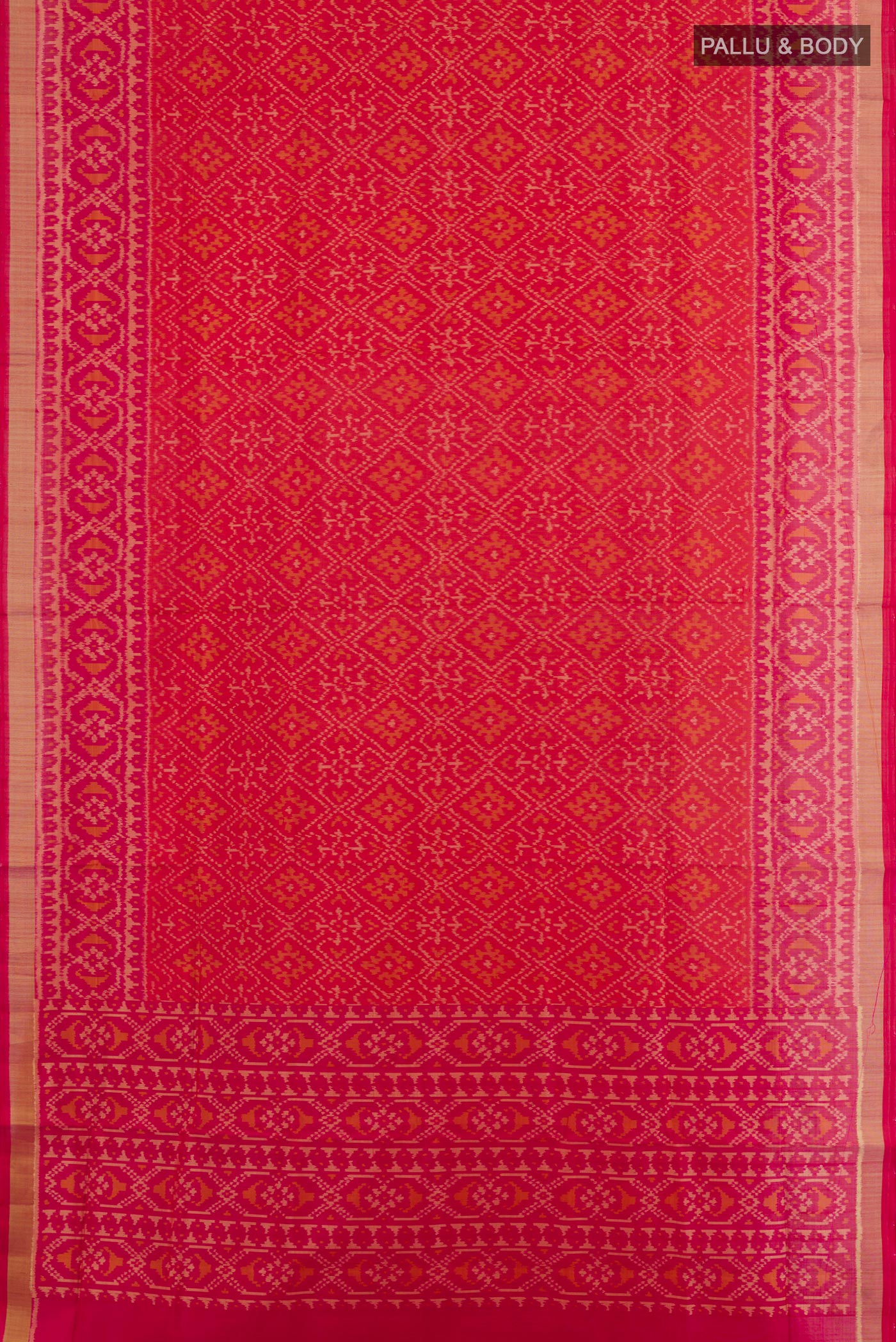 Flat view of Red Rajkot Patola Silk Saree with Ikat design on the body and Zari Border. 