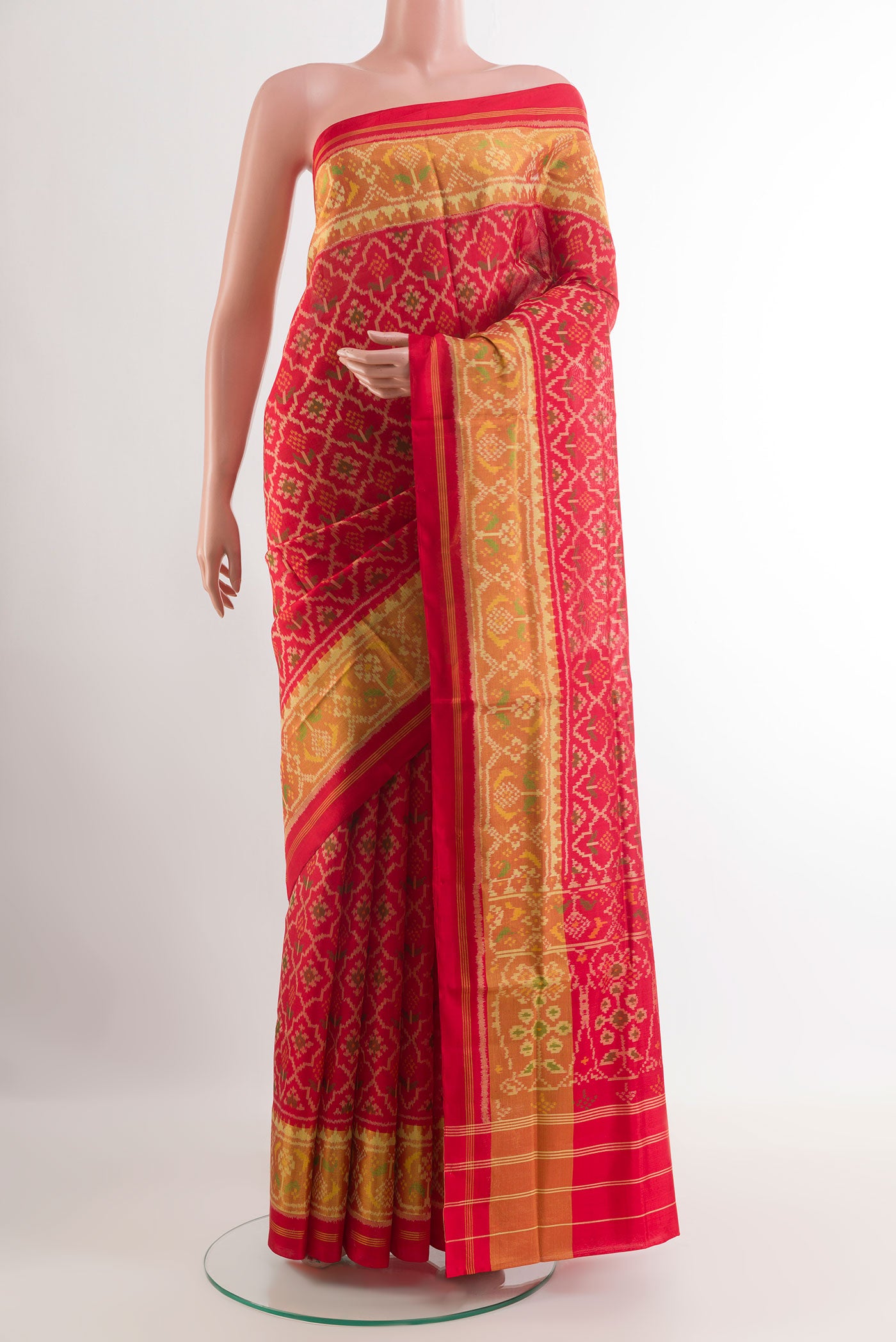 Red Rajkot Patola Silk Saree with Pure Ikat on the body and Zari Border.  displayed on a mannequin