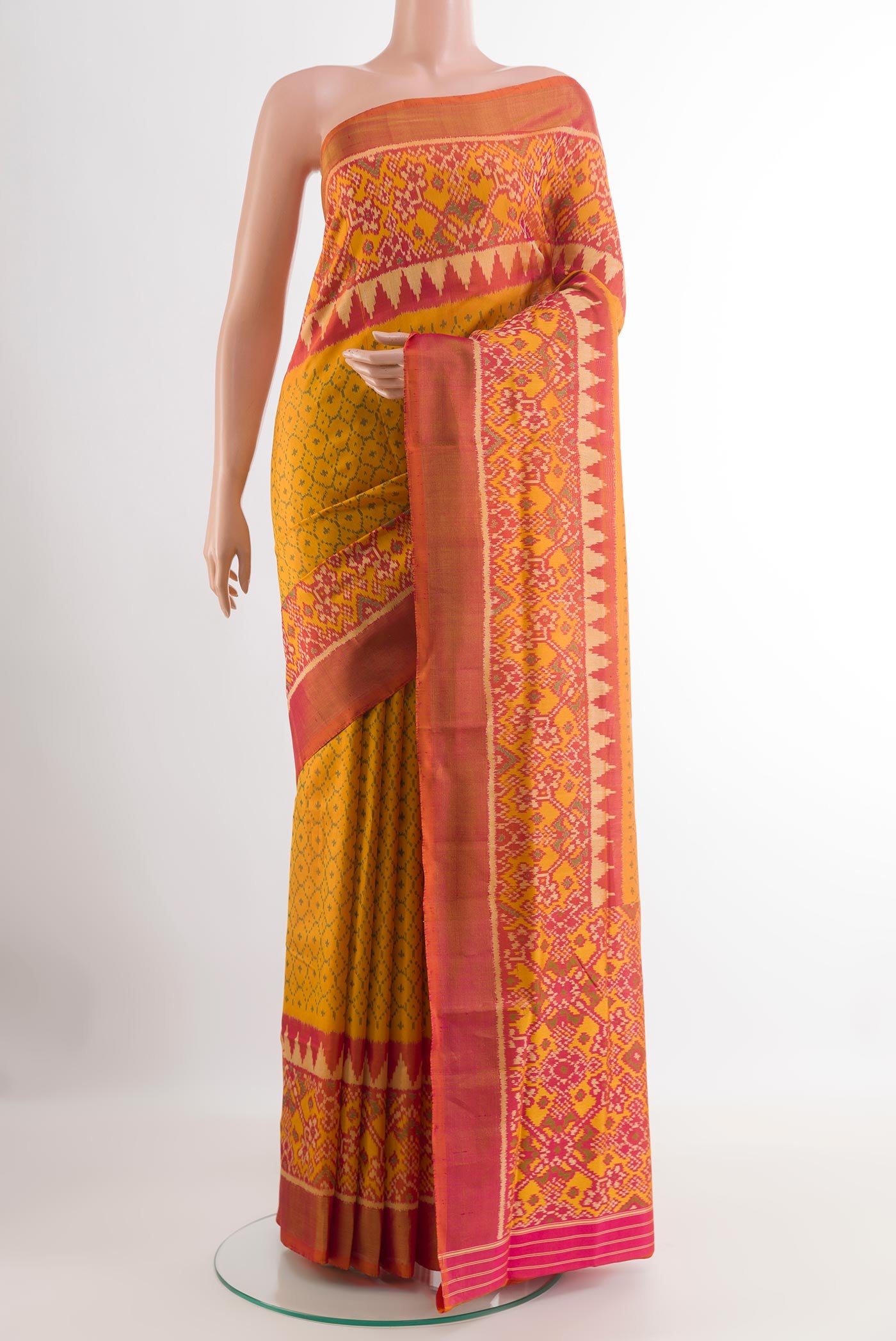 Yellow Rajkot Patola Silk Saree with Pure Ikat on the body and Zari Border.  displayed on a mannequin