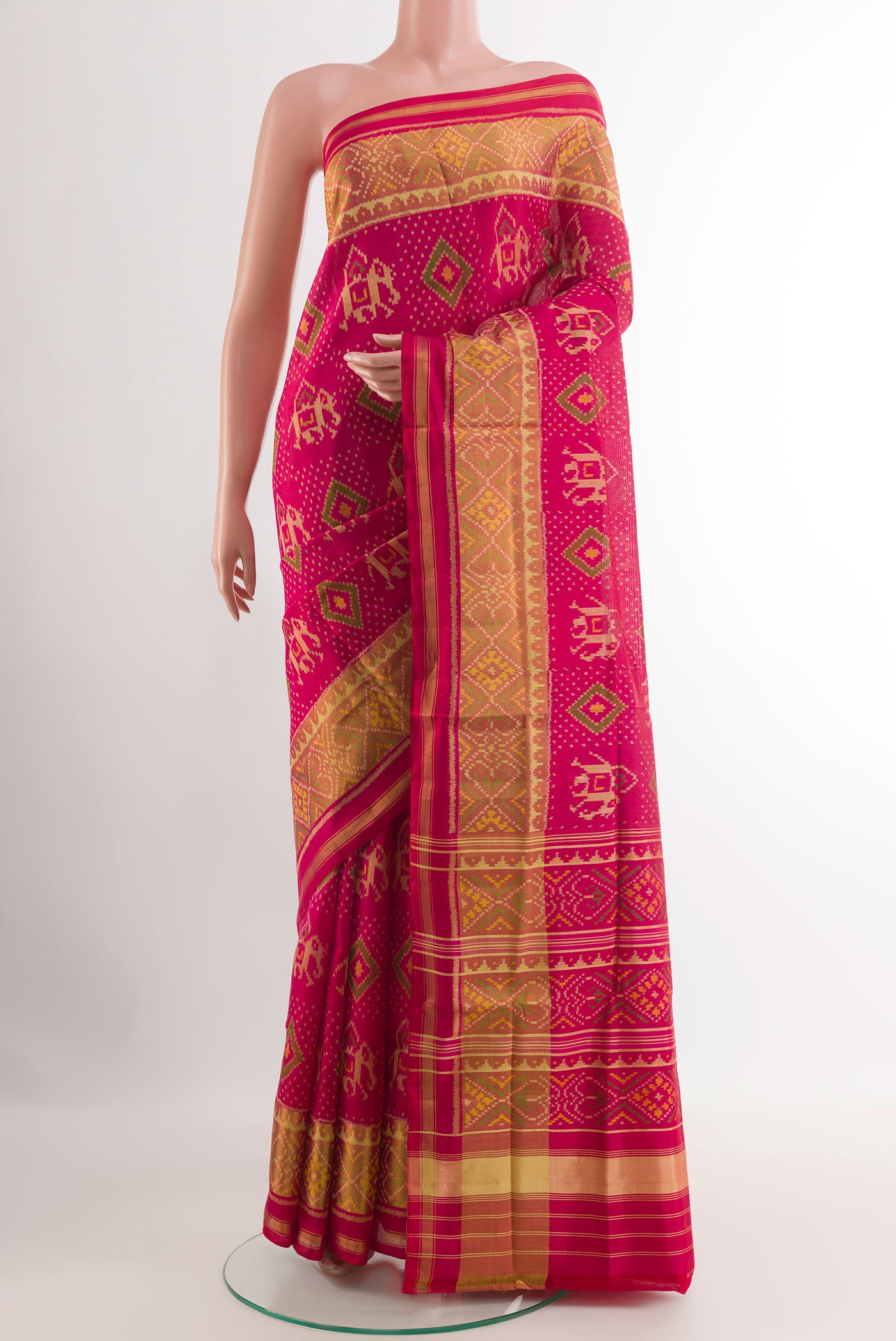 Pink Rajkot Patola Silk Saree with Pure Ikat on the body and Zari Border.  displayed on a mannequin