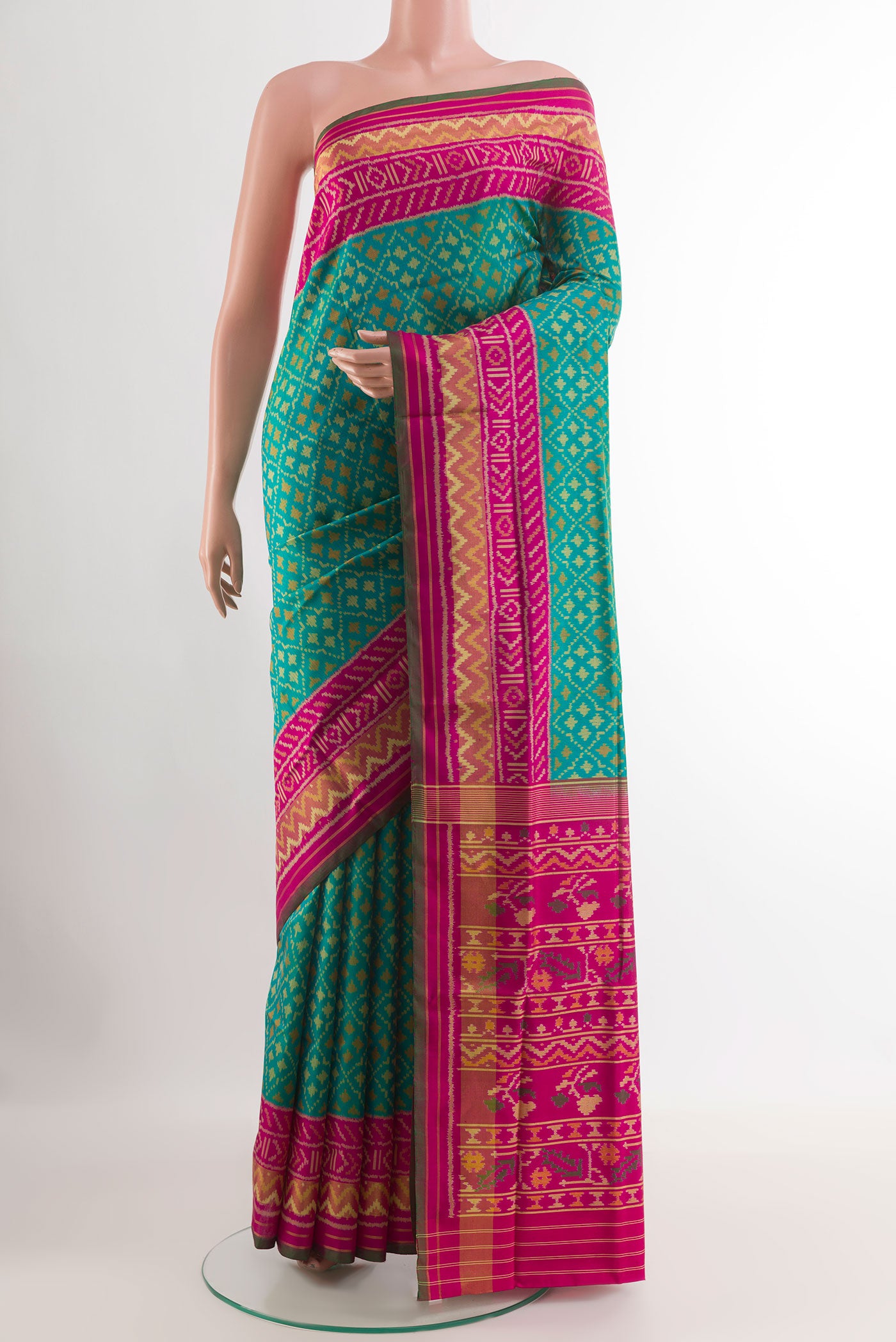 Blue Rajkot Patola Silk Saree with Pure Ikat on the body and Zari Border.  displayed on a mannequin