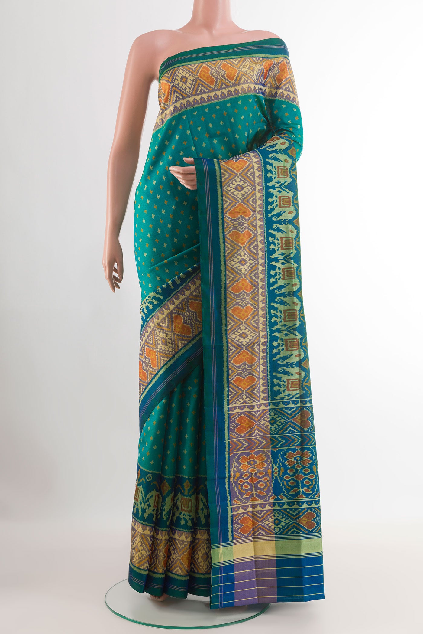 Peacock Blue Rajkot Patola Silk Saree with Pure Ikat on the body and Zari Border.  displayed on a mannequin