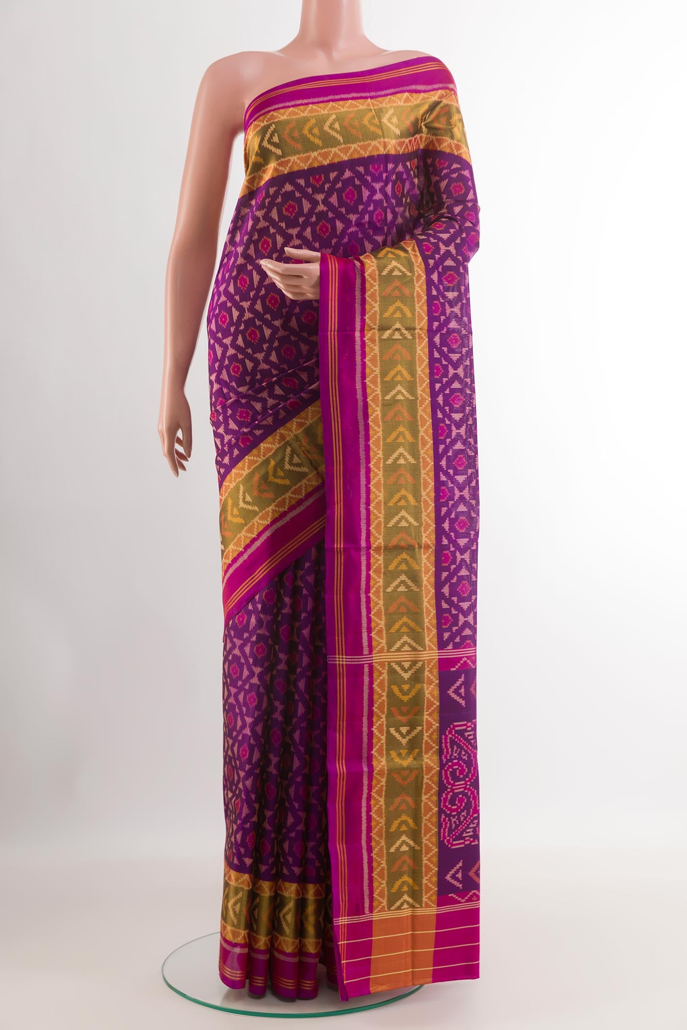 Purple Rajkot Patola Silk Saree with Ikat design on the body and Zari Border.  displayed on a mannequin