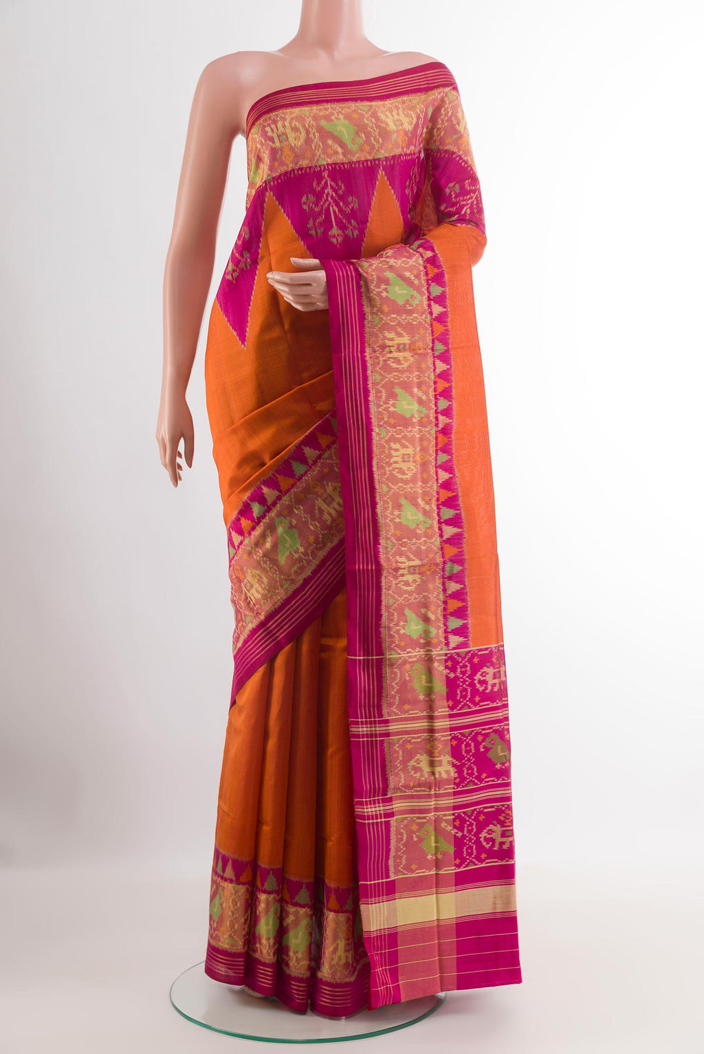 Orange Rajkot Patola Silk Saree with Pure Ikat on the body and Zari Border.  displayed on a mannequin